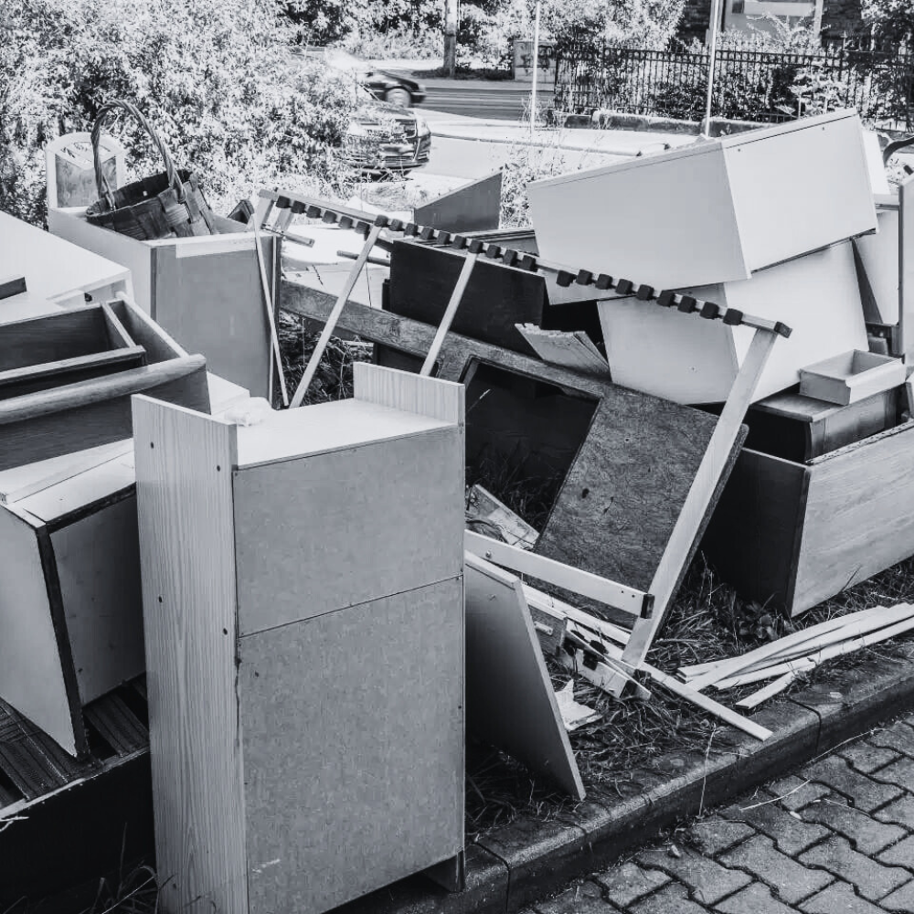 Old furniture and wooden cabinets discarded on a curbside for disposal in Australia