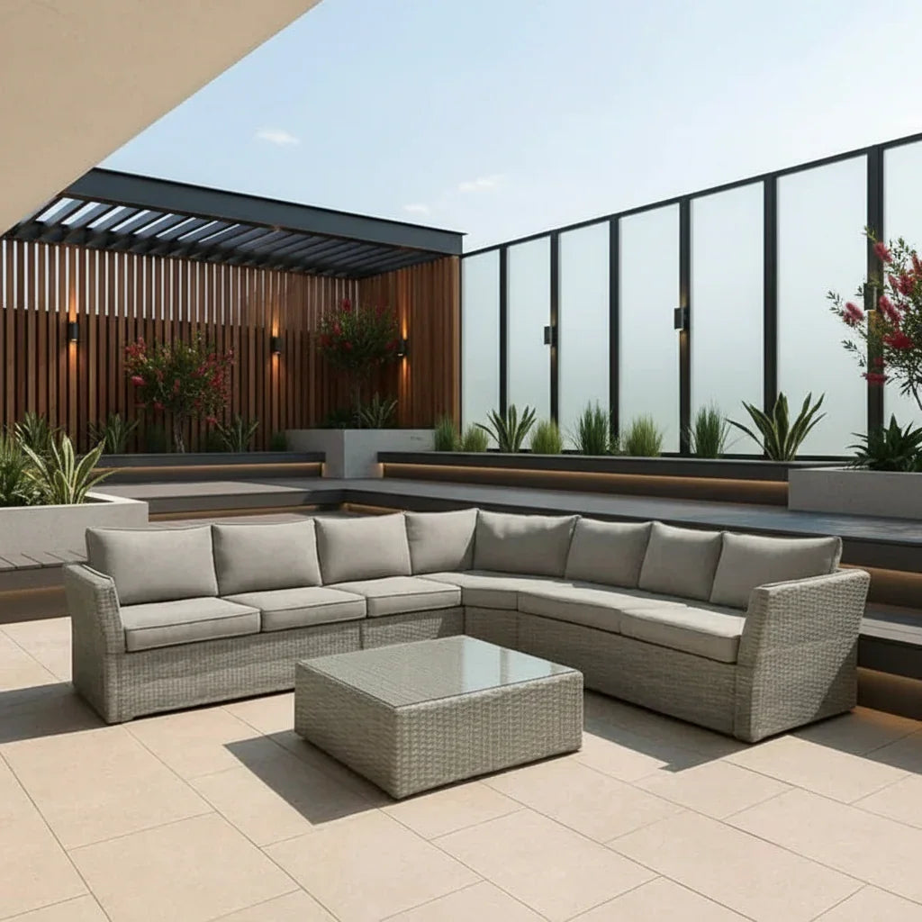 Outdoor patio with a sectional sofa and coffee table on a sunny day.