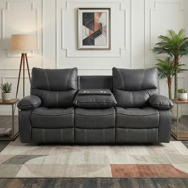 Brooke 3 Seater Recliner Lounge in dark grey leather with plush cushions, featuring a middle folding armrest with cup holders, set in a modern living room with neutral decor.