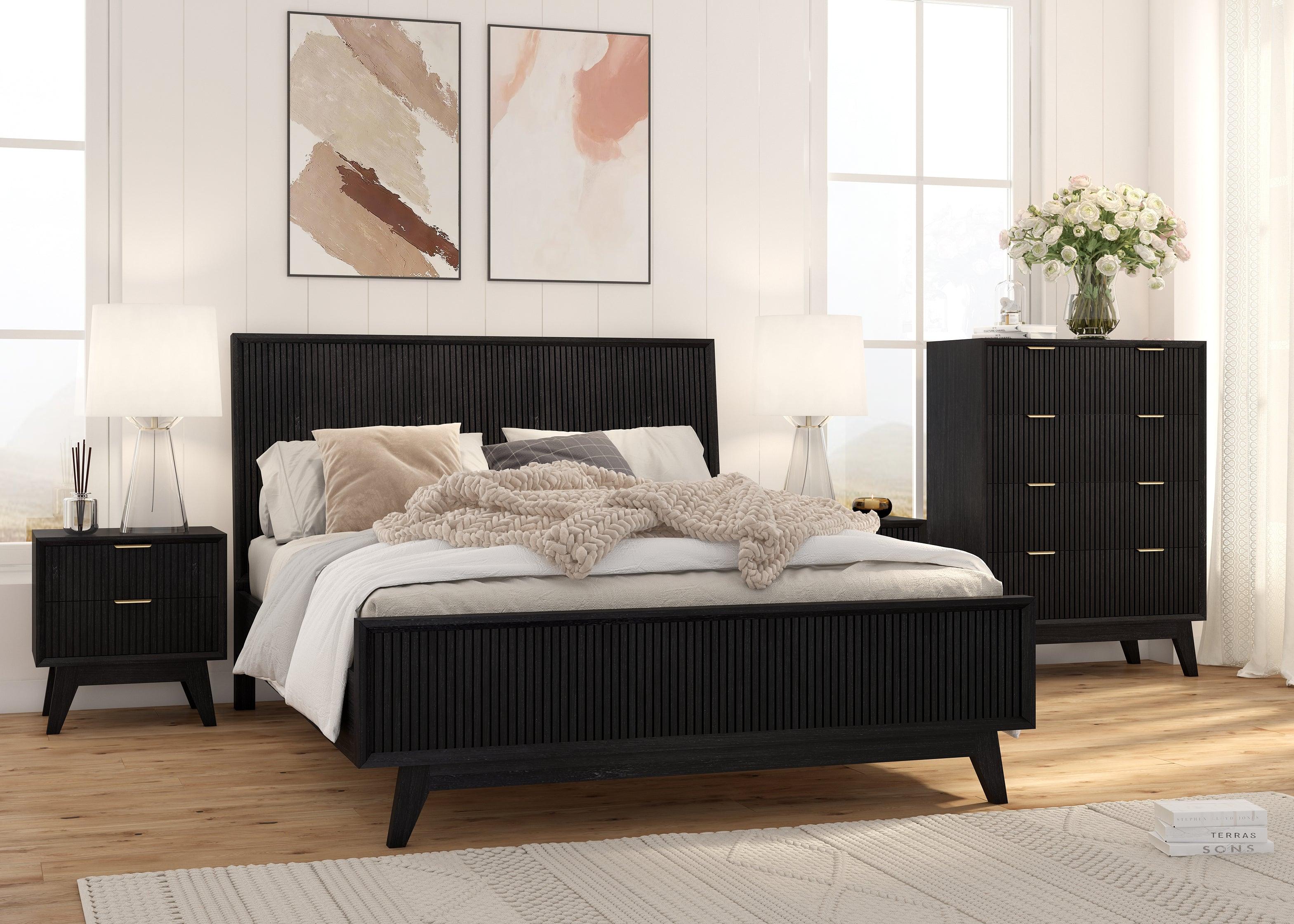 Modern black bedroom suite with queen bed, dresser, bedside tables, and neutral decor.