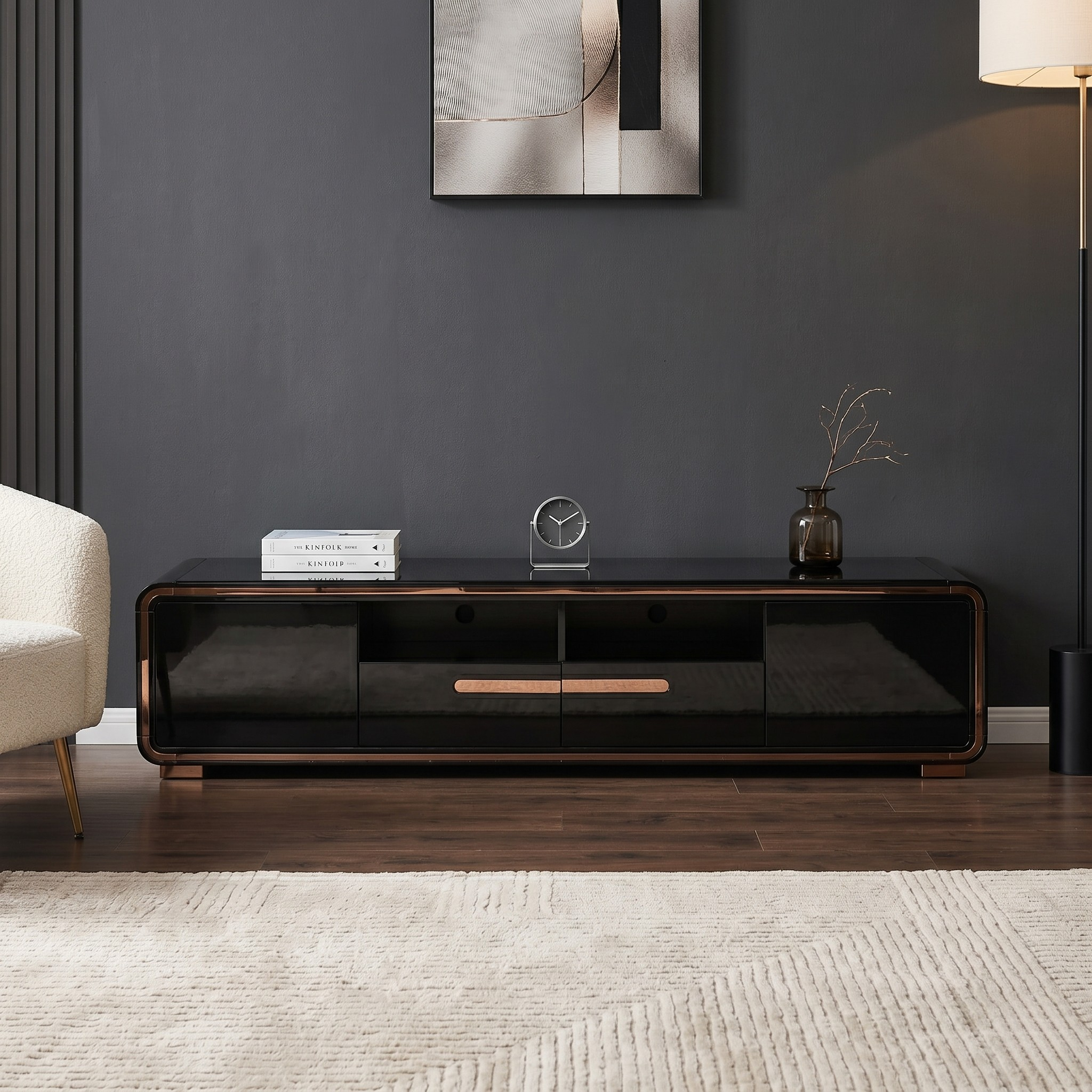 Modern black TV stand in a living room with a dark gray wall and beige rug.