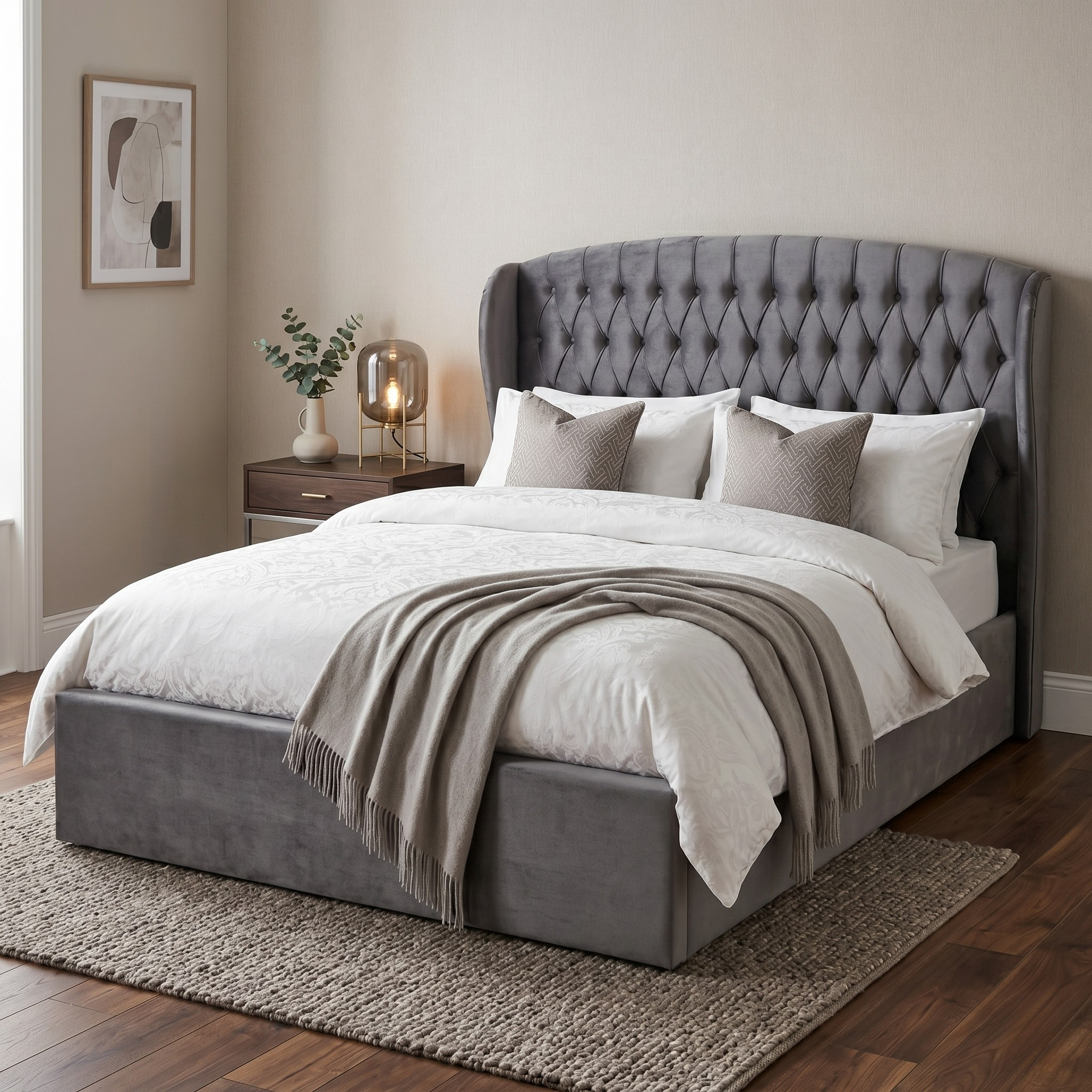 Gray upholstered bed with tufted headboard in a bedroom setting.