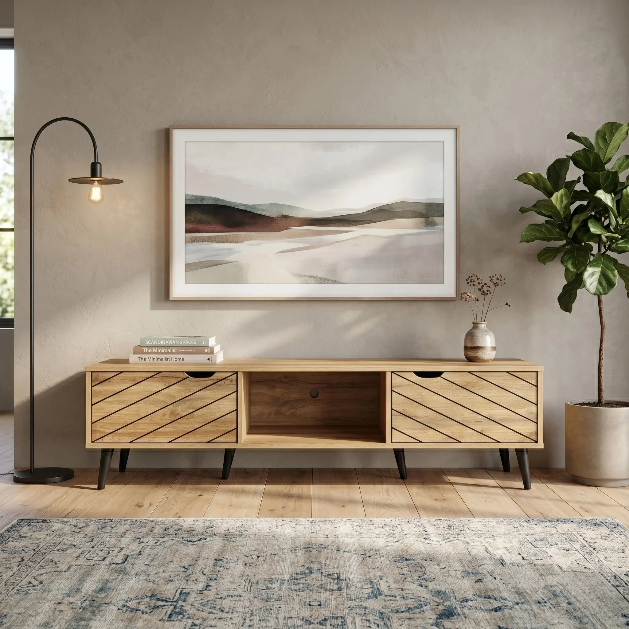 Wooden TV stand in a living room with a landscape painting above it, a plant to the right, and a rug on the floor.