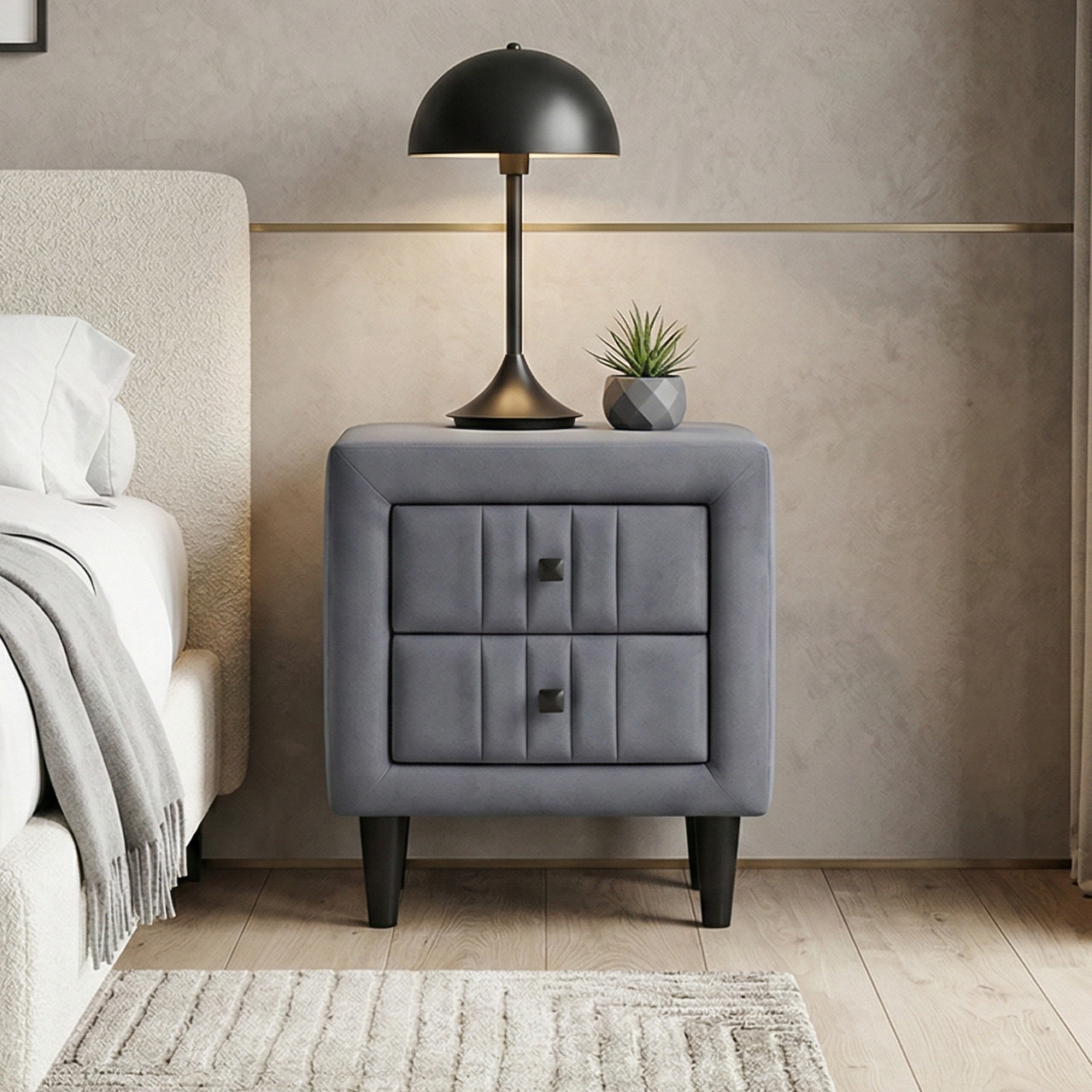 Modern bedside table in grey fabric with a bed on one side, a nightstand, and a lamp.
