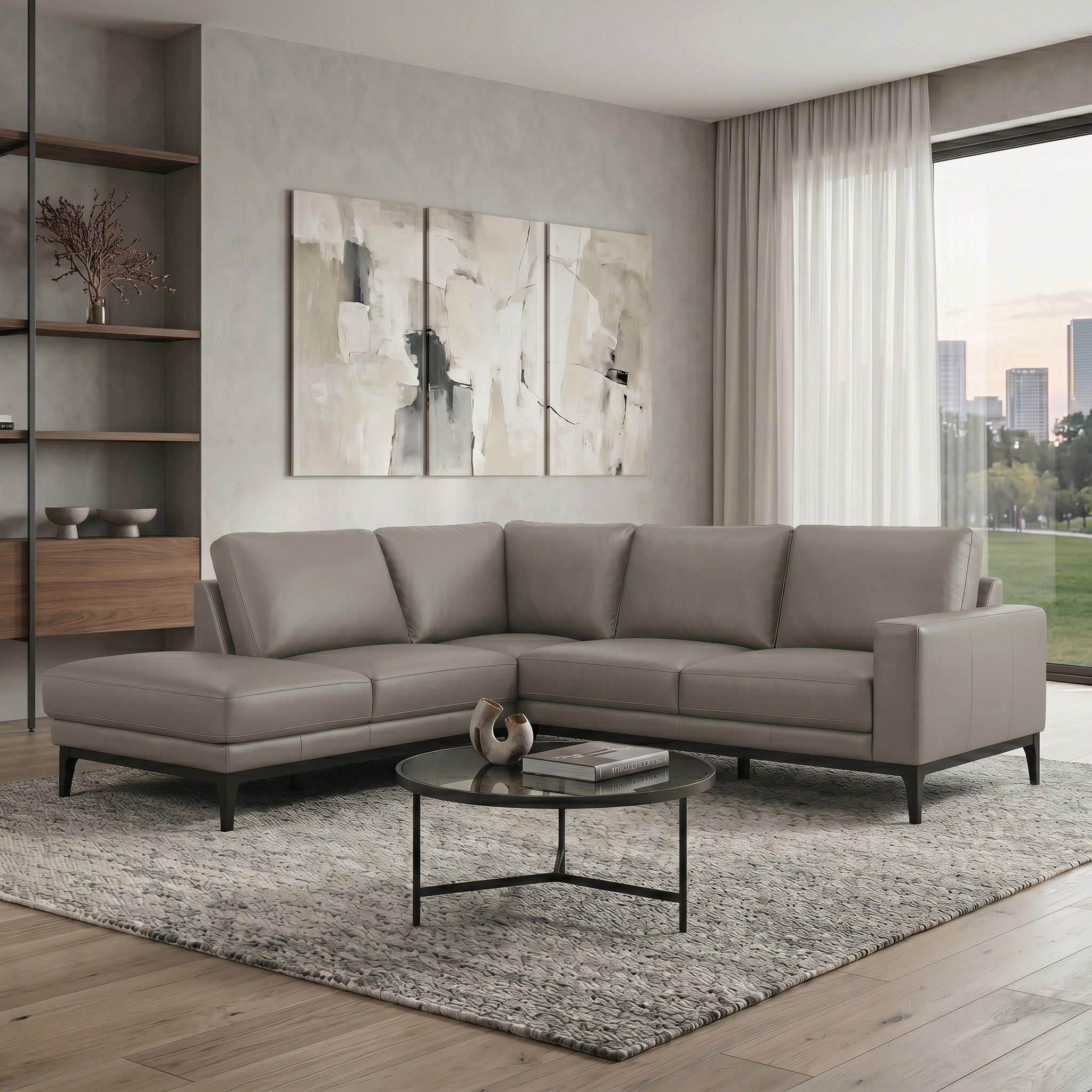 Modern living room with a gray sectional sofa, coffee table, and abstract wall art.