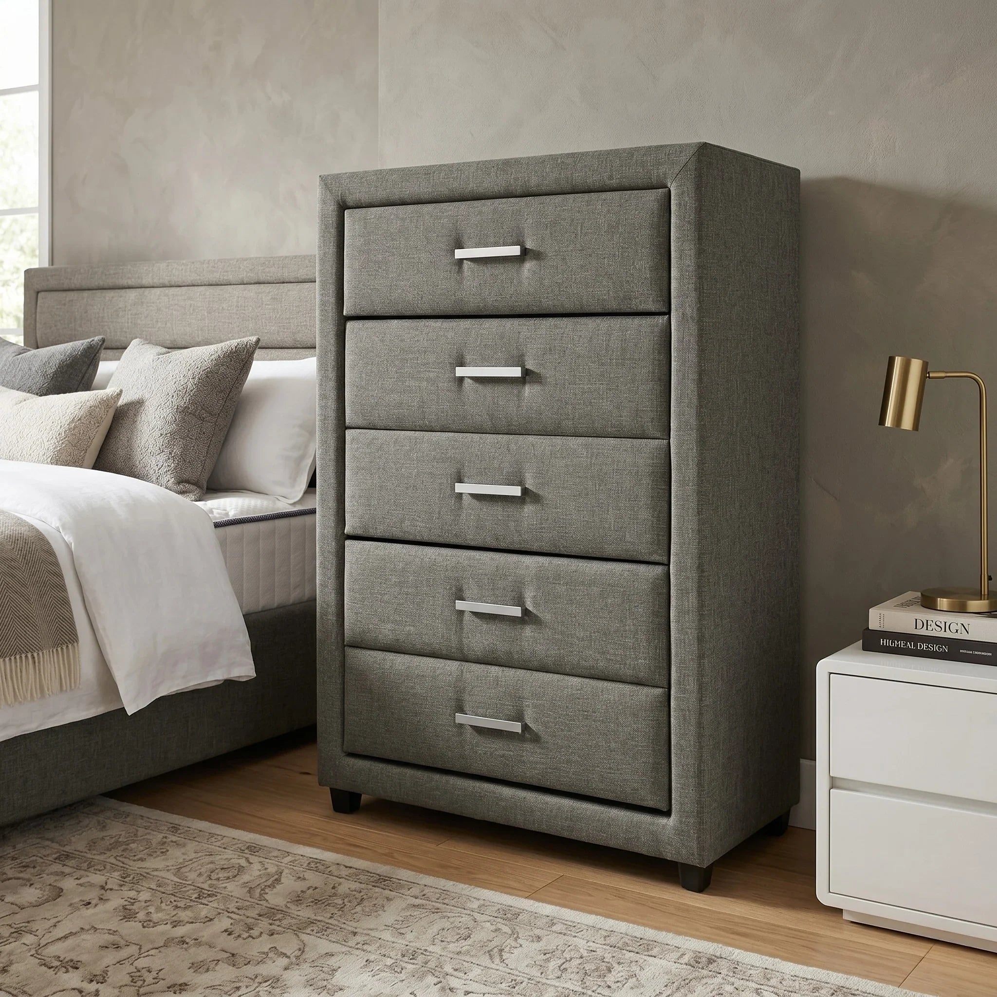 Gray dresser in a bedroom setting with a bed and lamp in the background