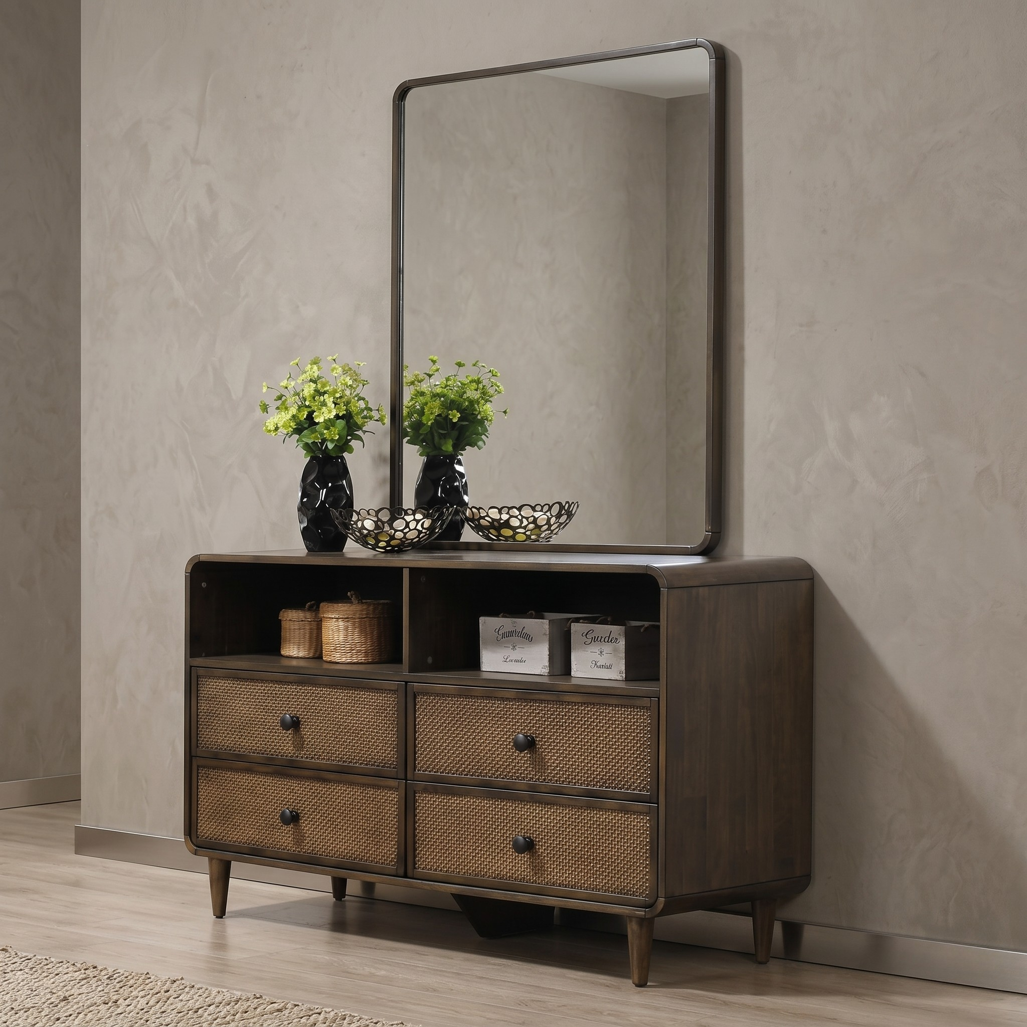 Wooden dresser with four drawers and a mirror above it against a beige wall.