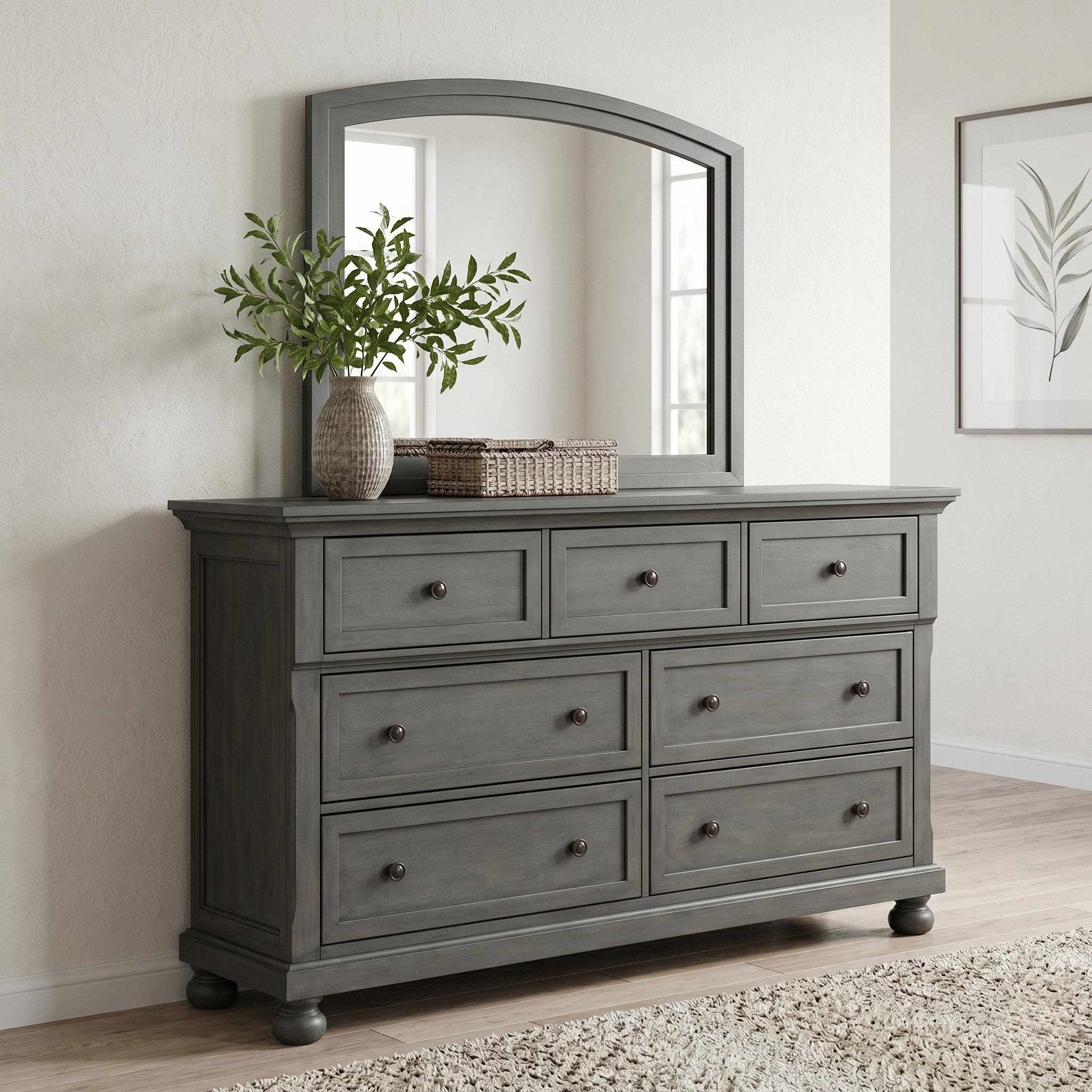 Gray dresser with mirror, plant, and basket in a room setting