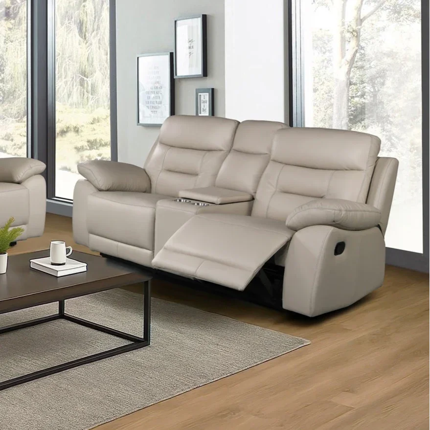 Beige reclining sofa in a living room setting with large windows.