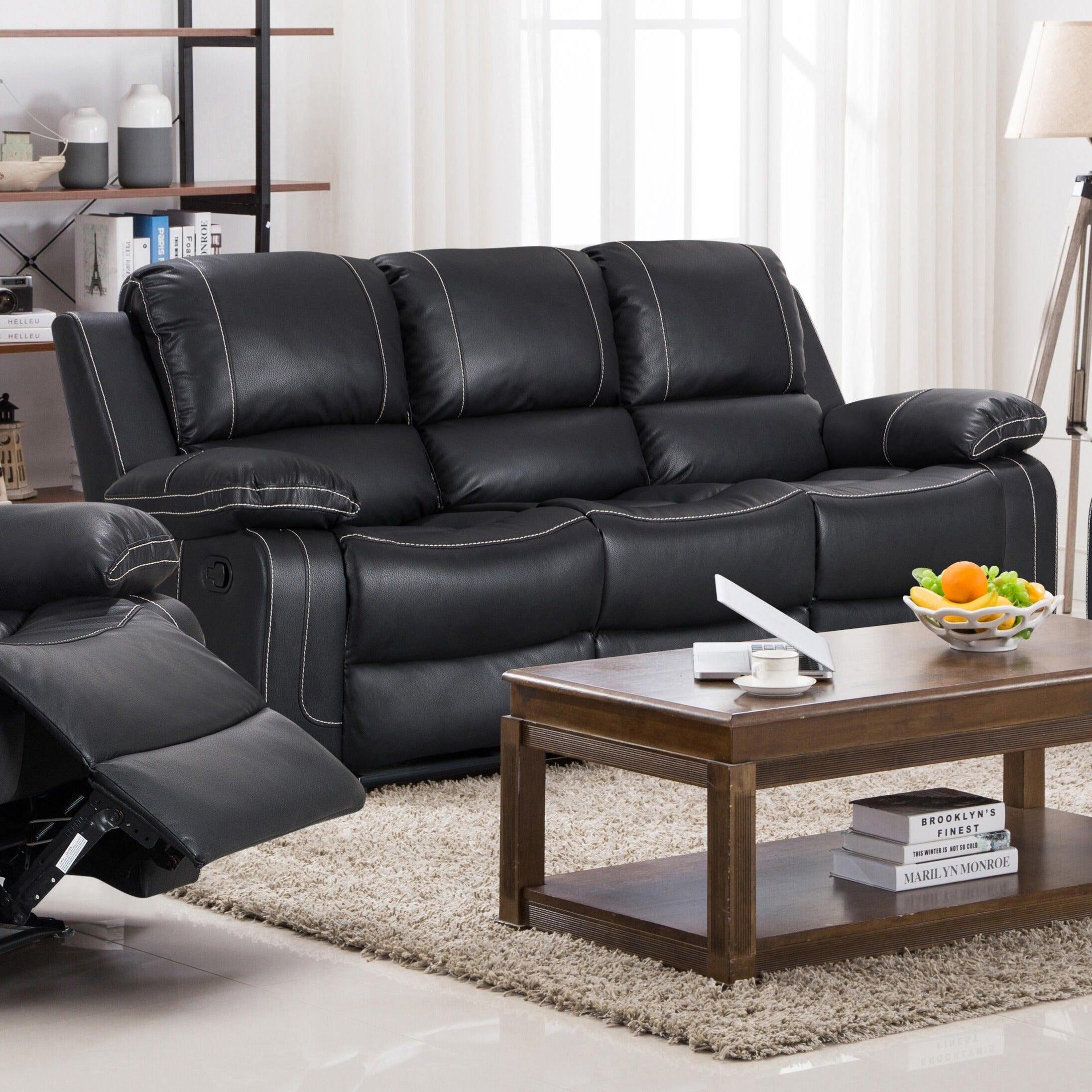 Black leather recliner sofa in modern living room with wooden coffee table and bookshelf
