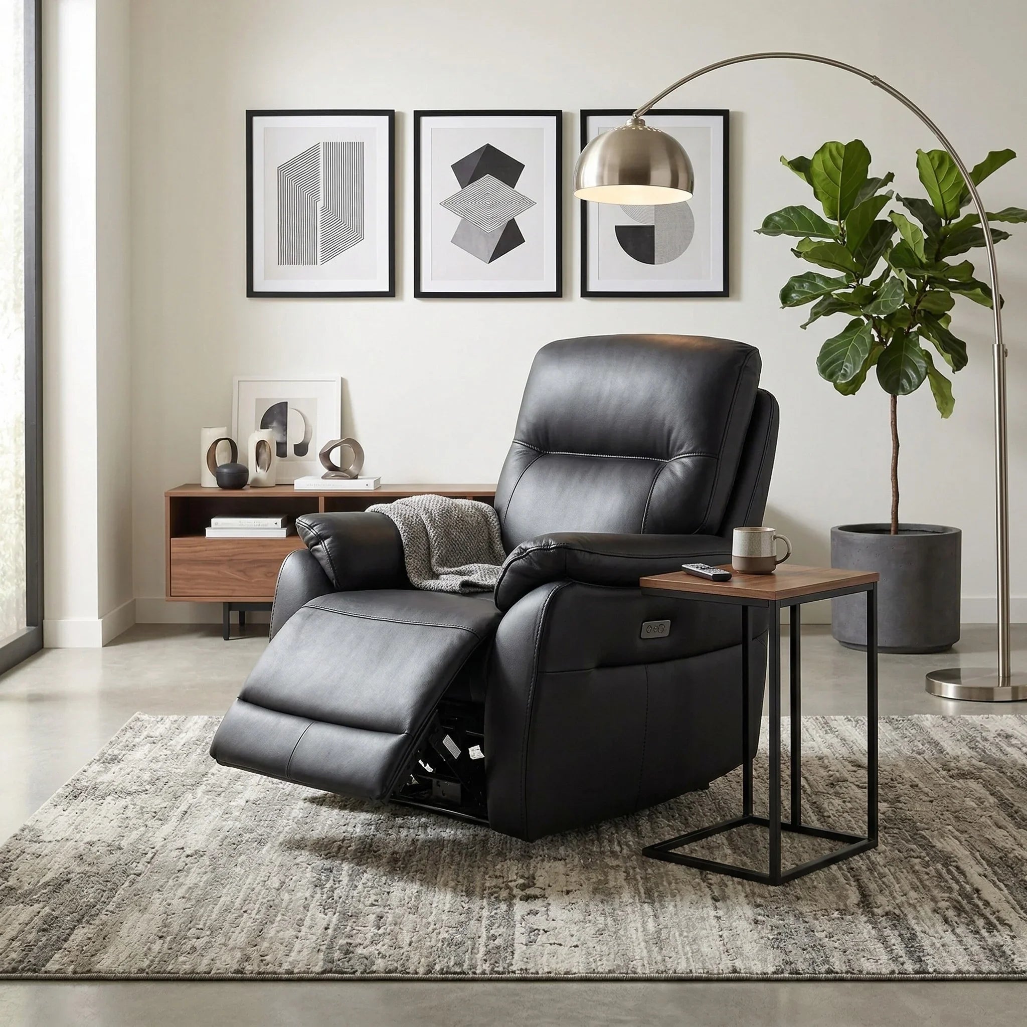 Armdale Leather Electric Recliner Chair in black leather, shown reclined in a modern living room setting with a side table, floor lamp, and decorative artwork.