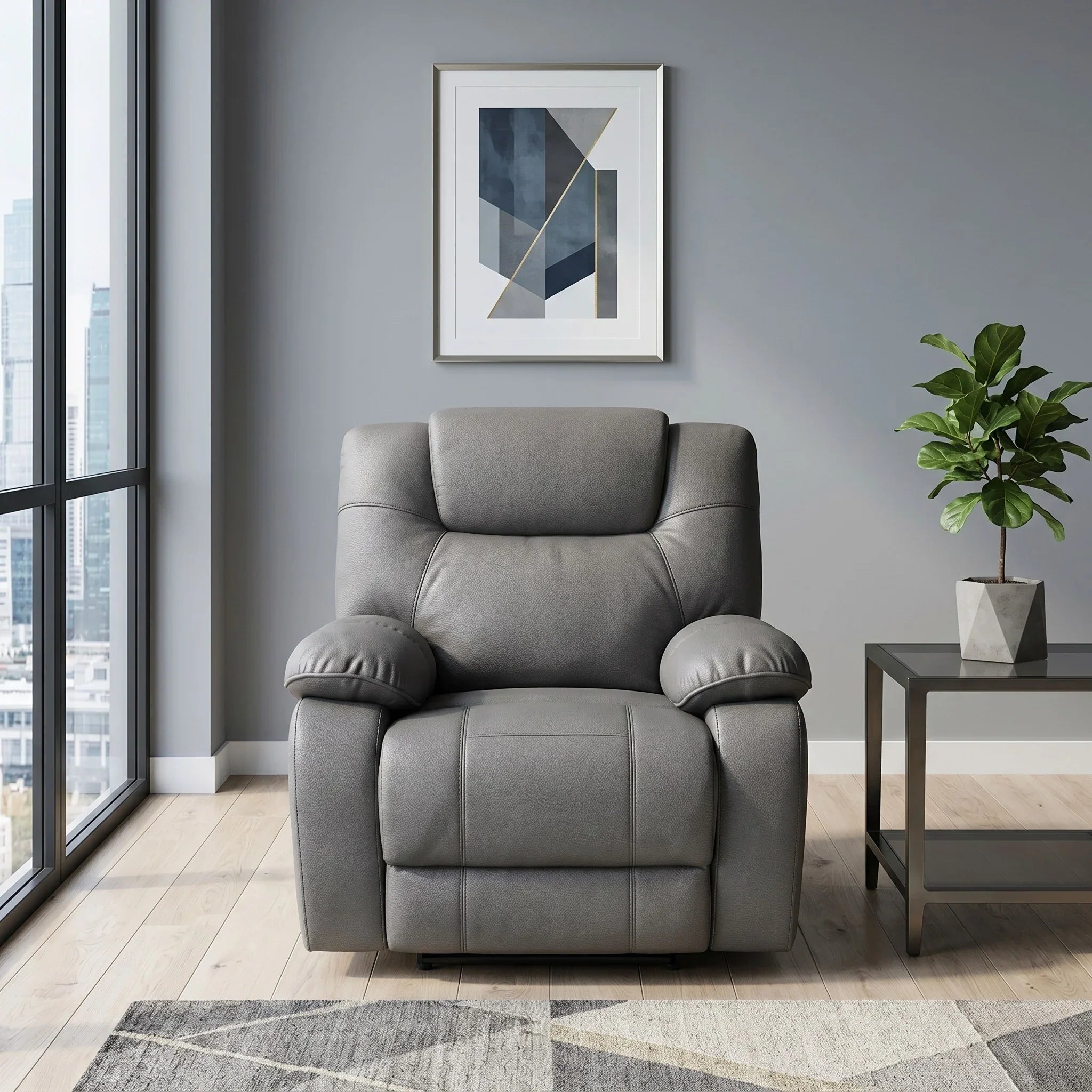 Ballarat Recliner Chair in gray leather positioned in a modern living room with large windows, featuring padded armrests and a cushioned backrest next to a side table with a plant.