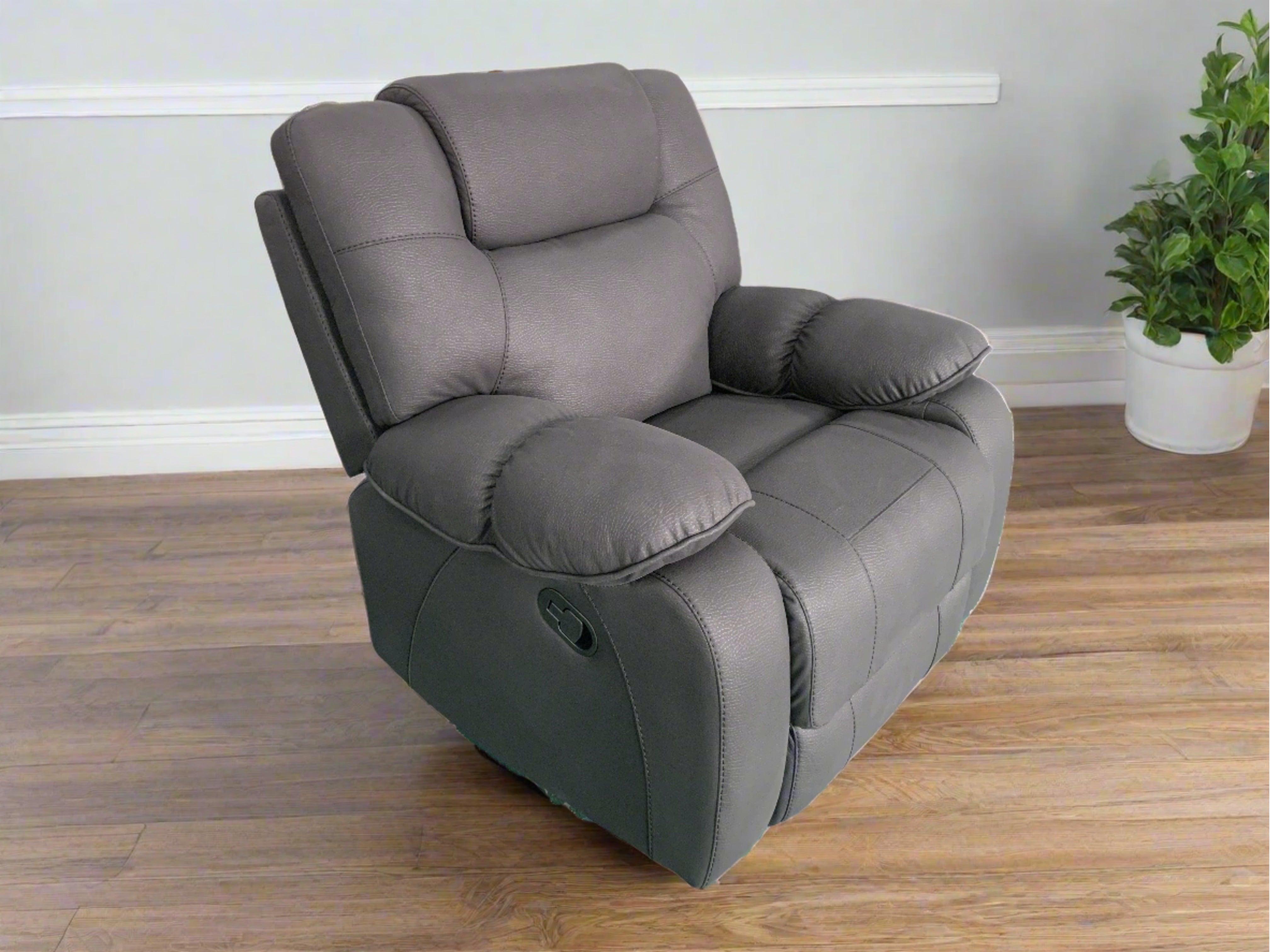 Grey fabric recliner armchair on wood flooring, modern living room setting, indoor plant