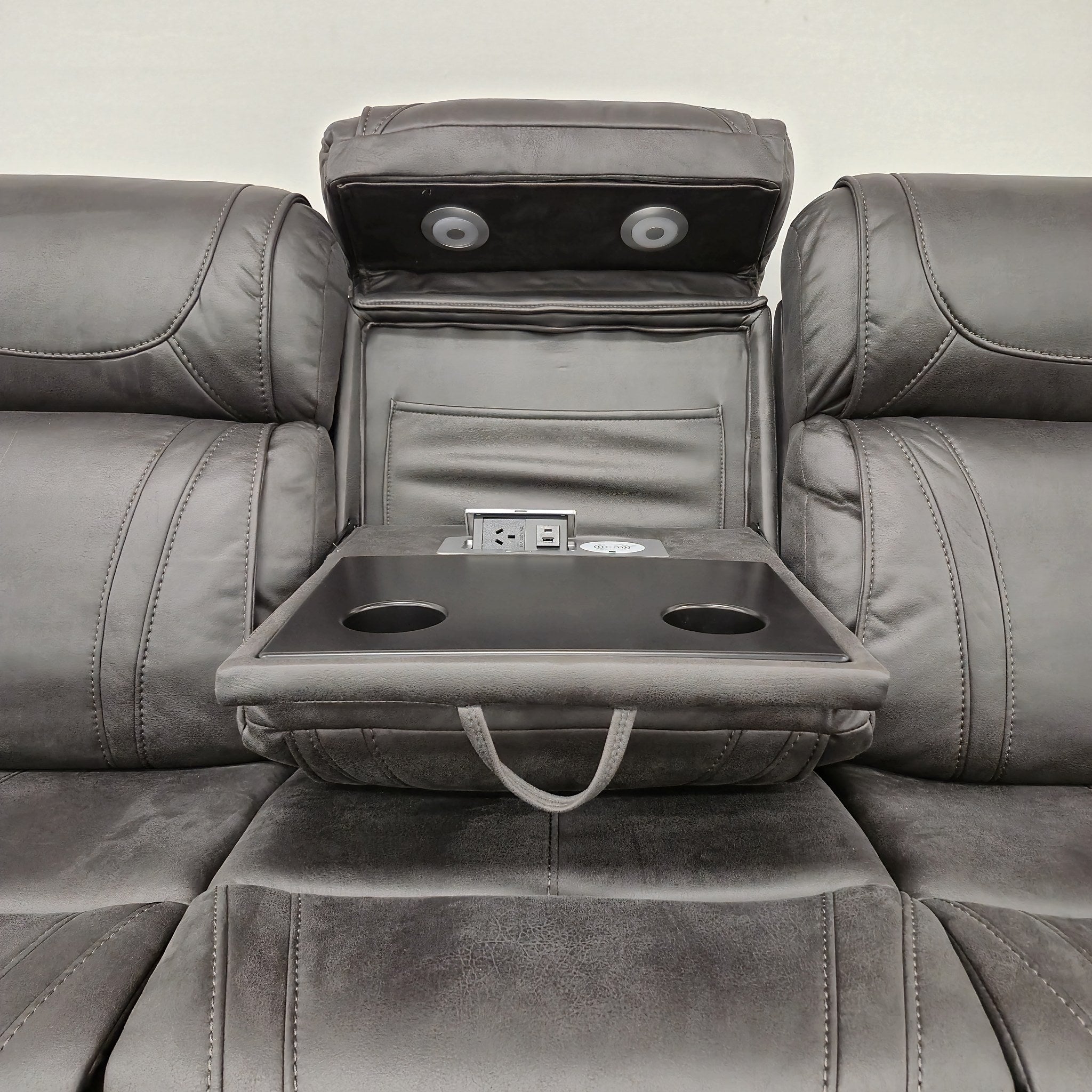 Ballina 3 Seater Electric Recliner Lounge in grey - drop-down centre console open, showing the padded tray with two cup holders, a power point, USB ports and a wireless charging pad