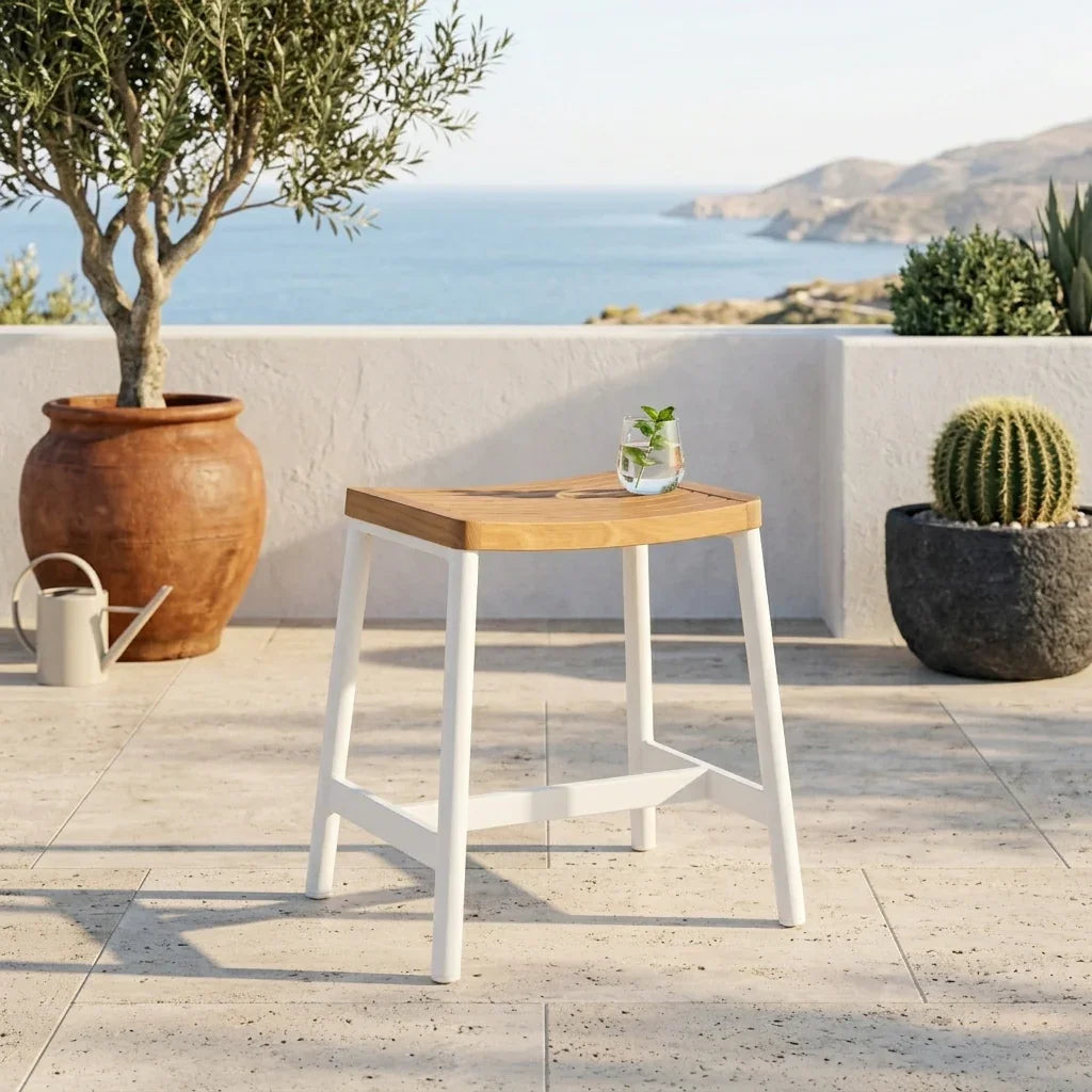 Wooden table with white legs on a patio with potted plants and ocean view