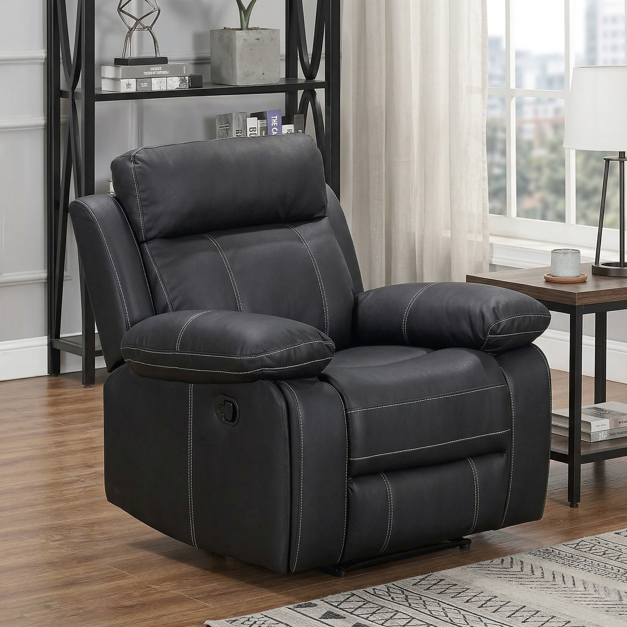 BLack recliner chair in a living room setting with a bookshelf and window in the background.