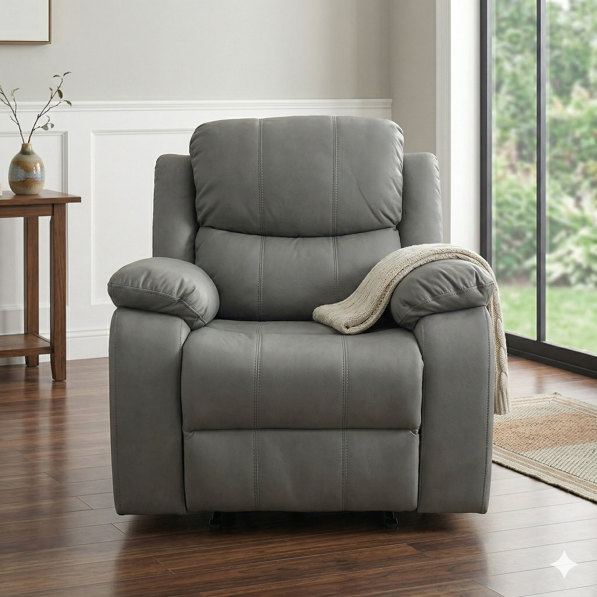 Gray recliner chair in a living room setting with a wooden side table and window in the background.