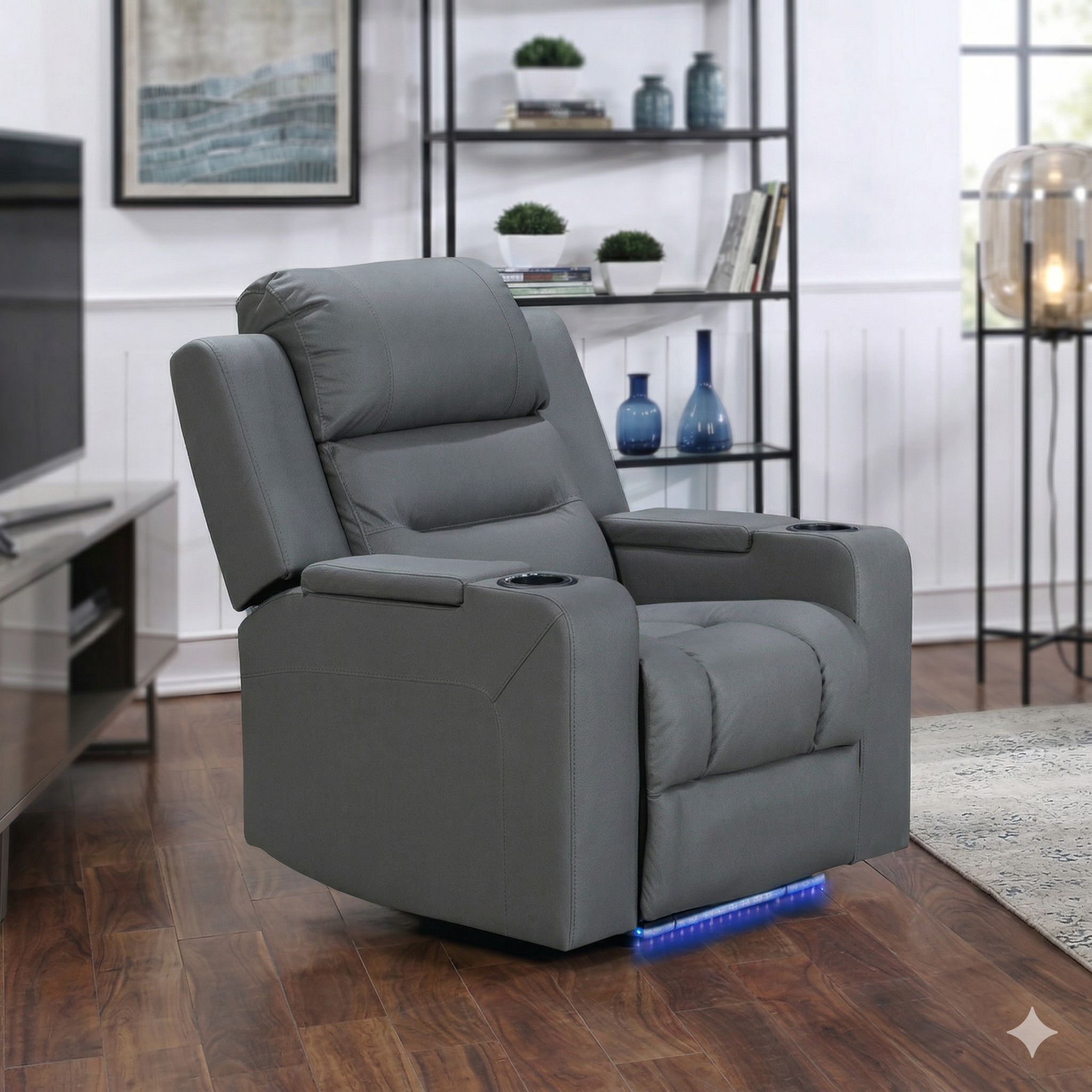 Gray recliner chair in a living room setting with wooden floor and shelves in the background.