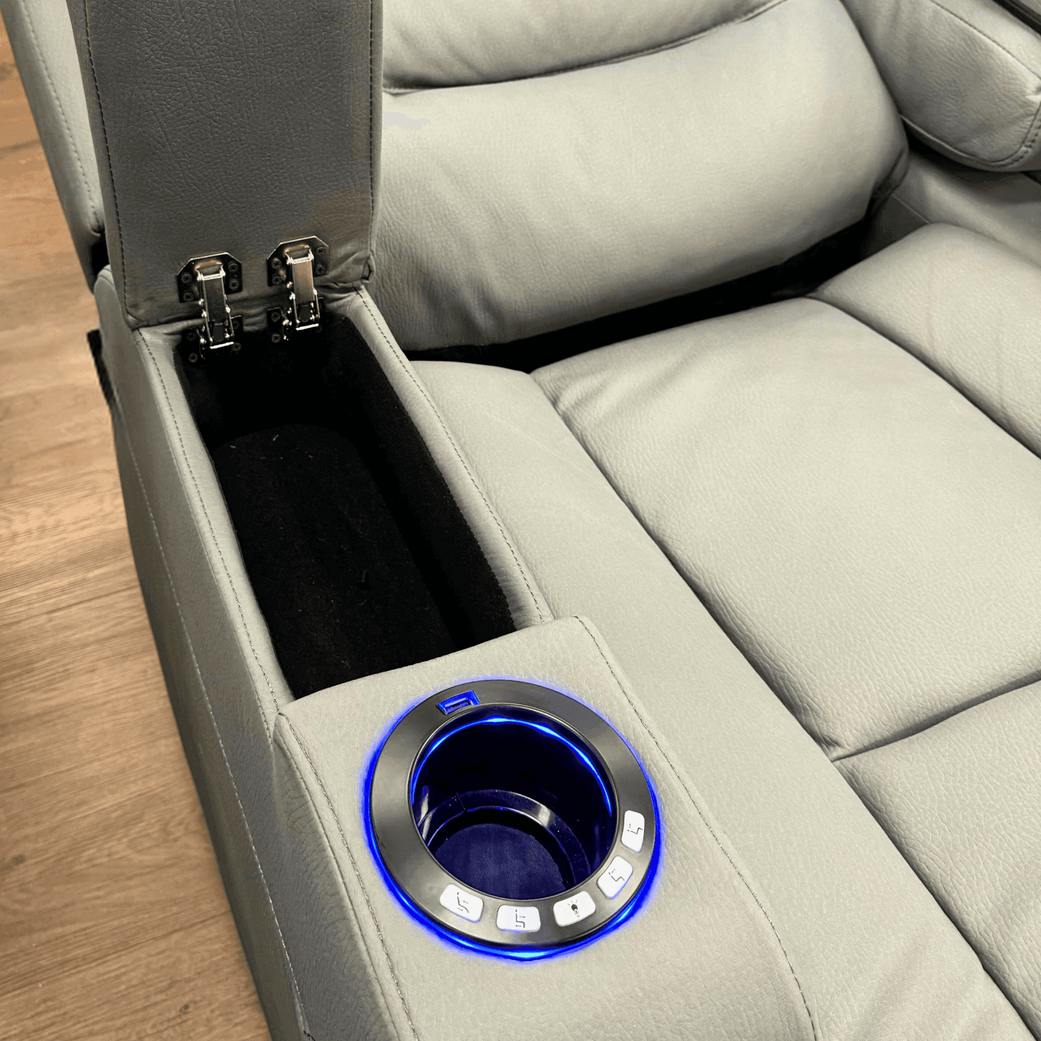 Grey electric recliner chair with illuminated cup holder, control buttons, and storage compartment