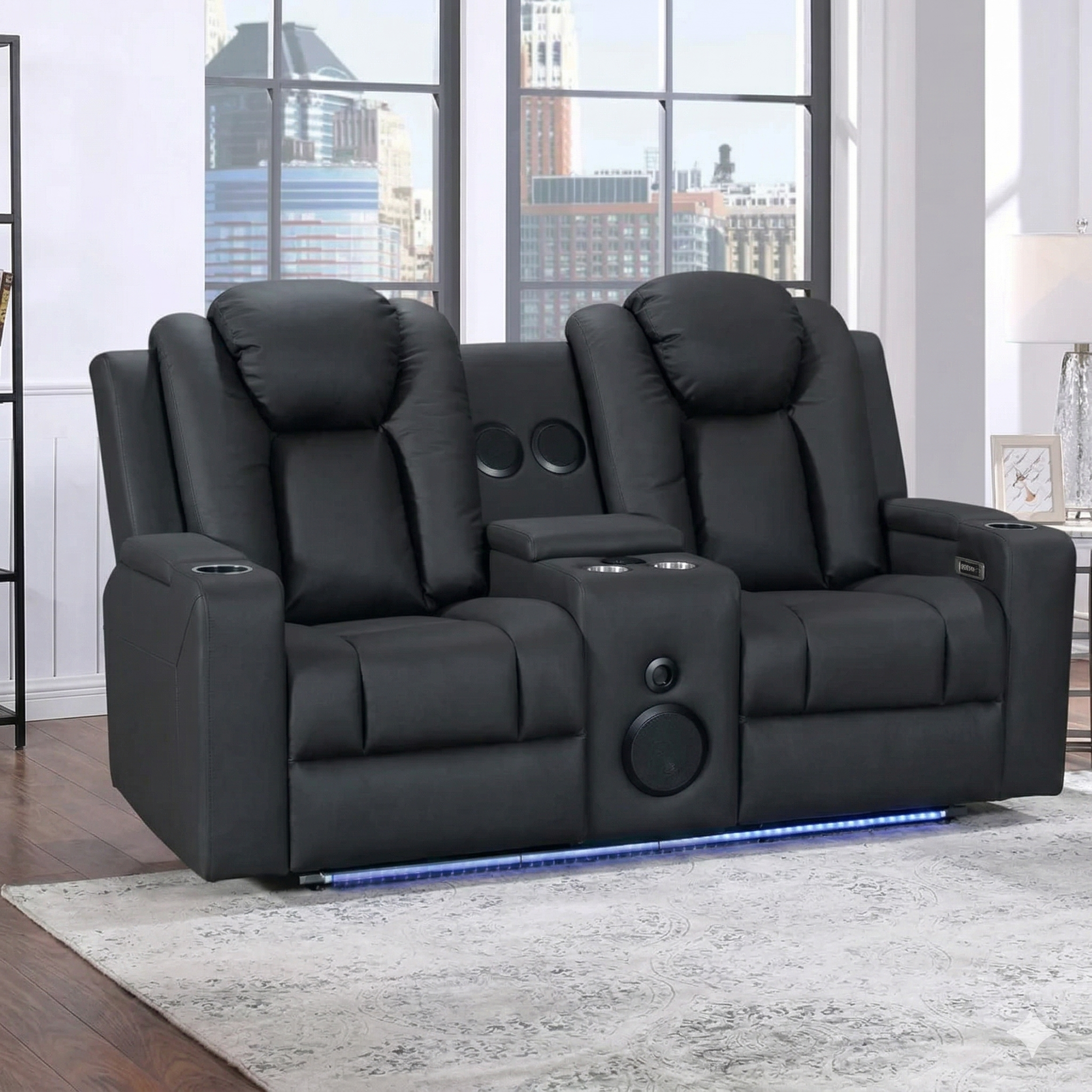 Black recliner sofa with cup holders and LED lighting in a room with large windows.