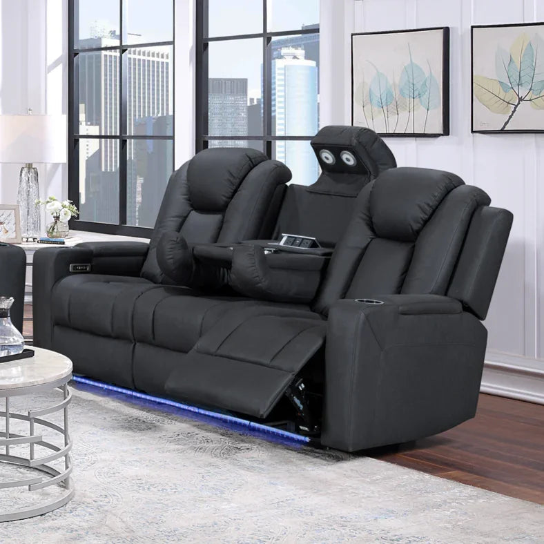 Black reclining home theater sofa with cup holders, fold-down tray, and LED lighting in modern living room.