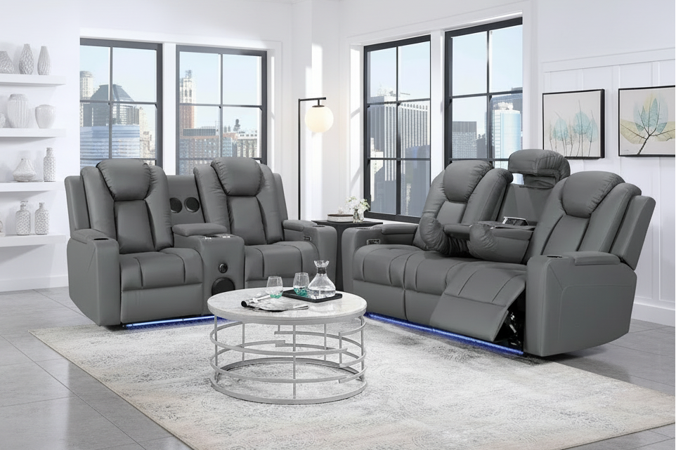 Gray reclining sofa set in a modern living room with large windows.