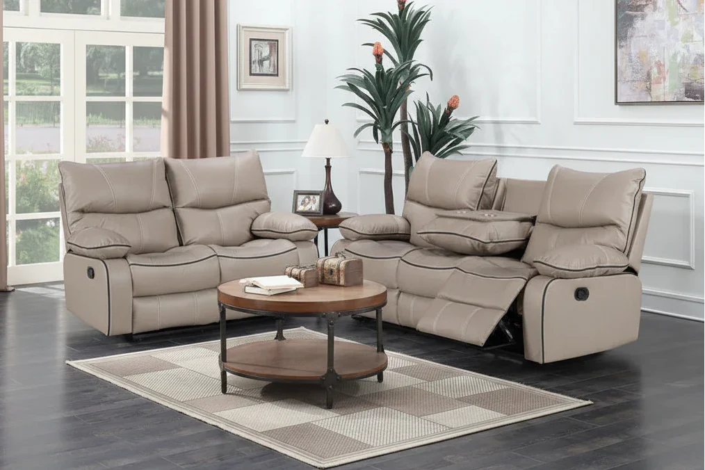 Beige reclining sofa set in a living room with a coffee table and decor items.