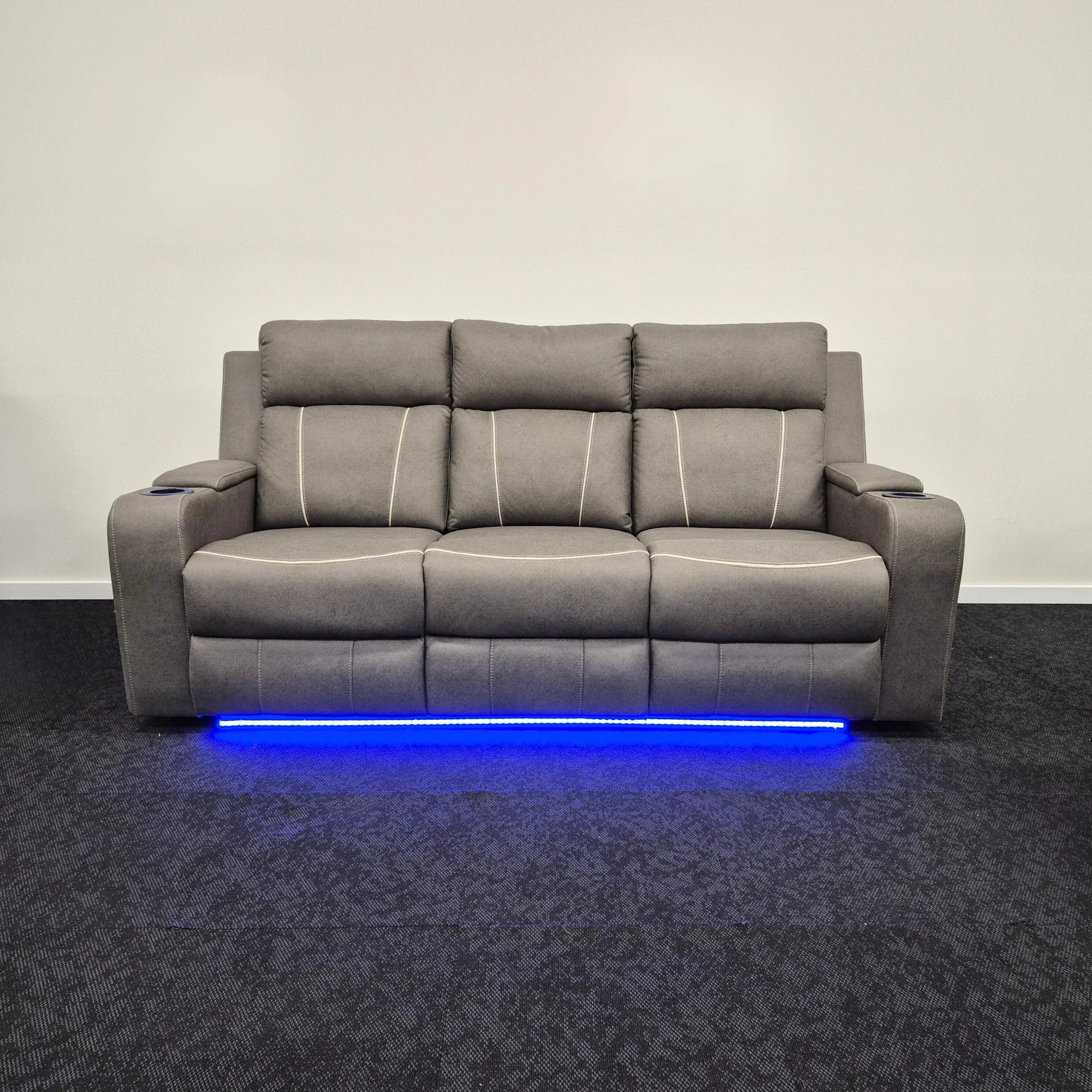 Grey three-seater electric recliner lounge with cup holders and blue LED lighting strip