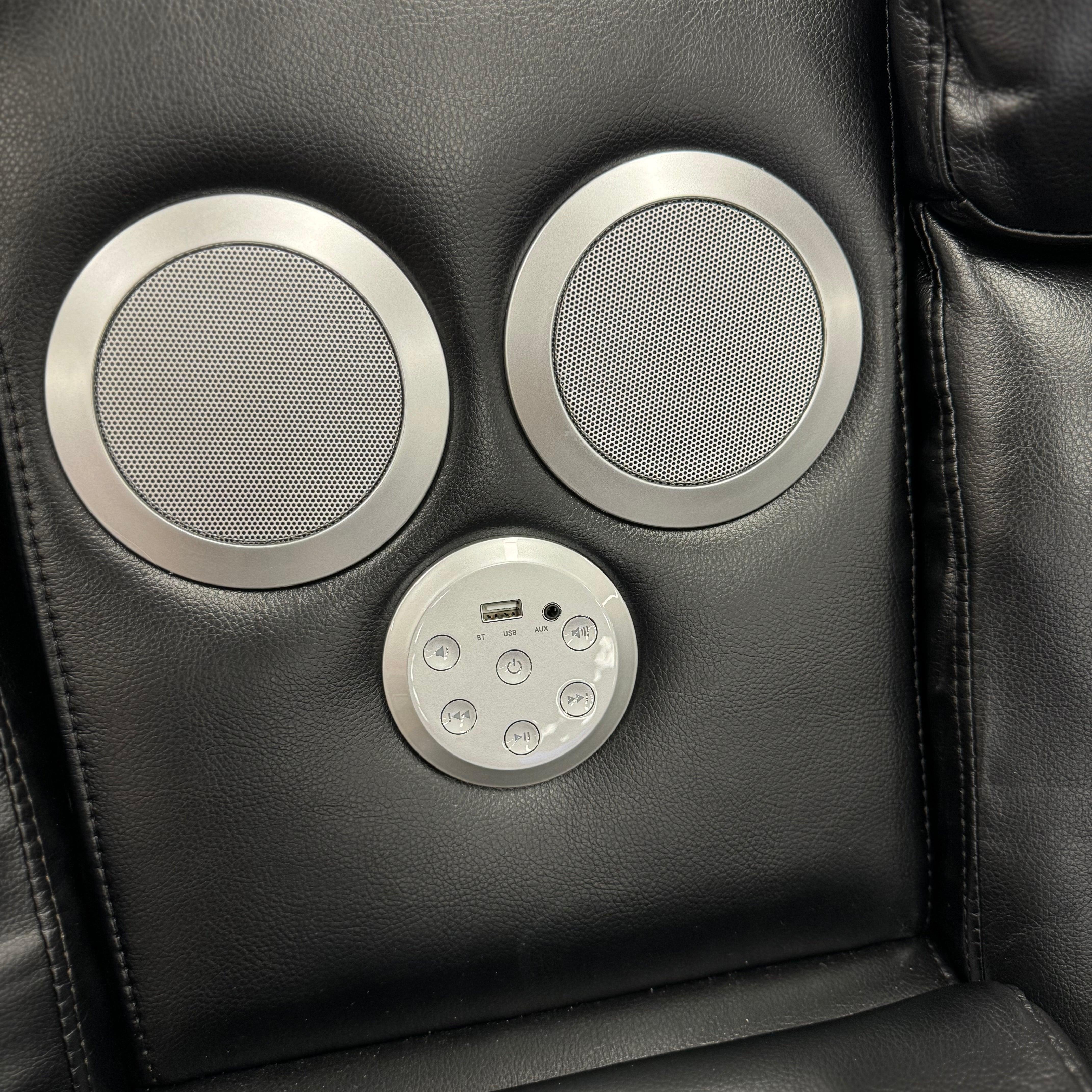 Close-up of leather recliner chair with built-in Bluetooth speakers and control panel