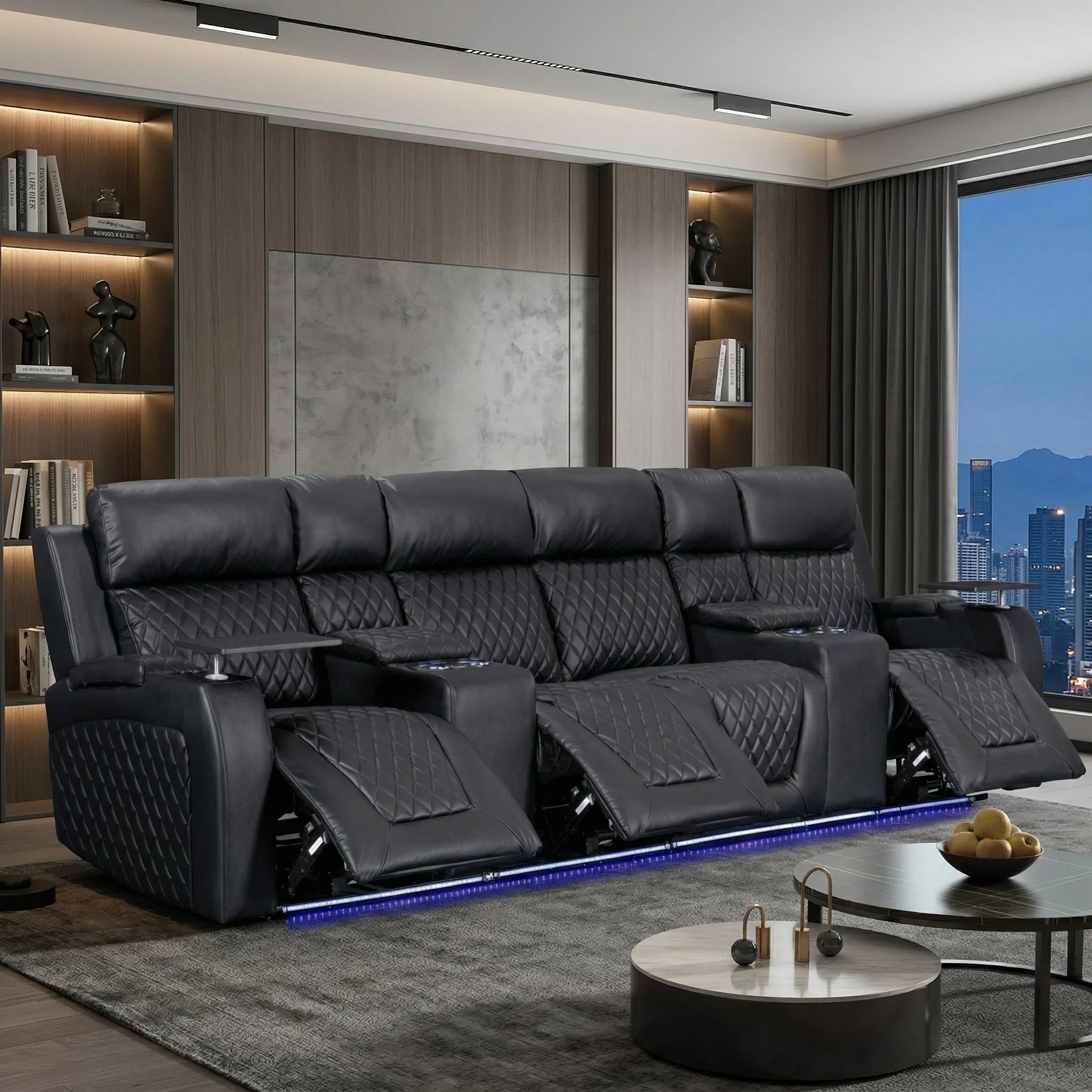 Modern living room with a large black leather sofa and cityscape view.