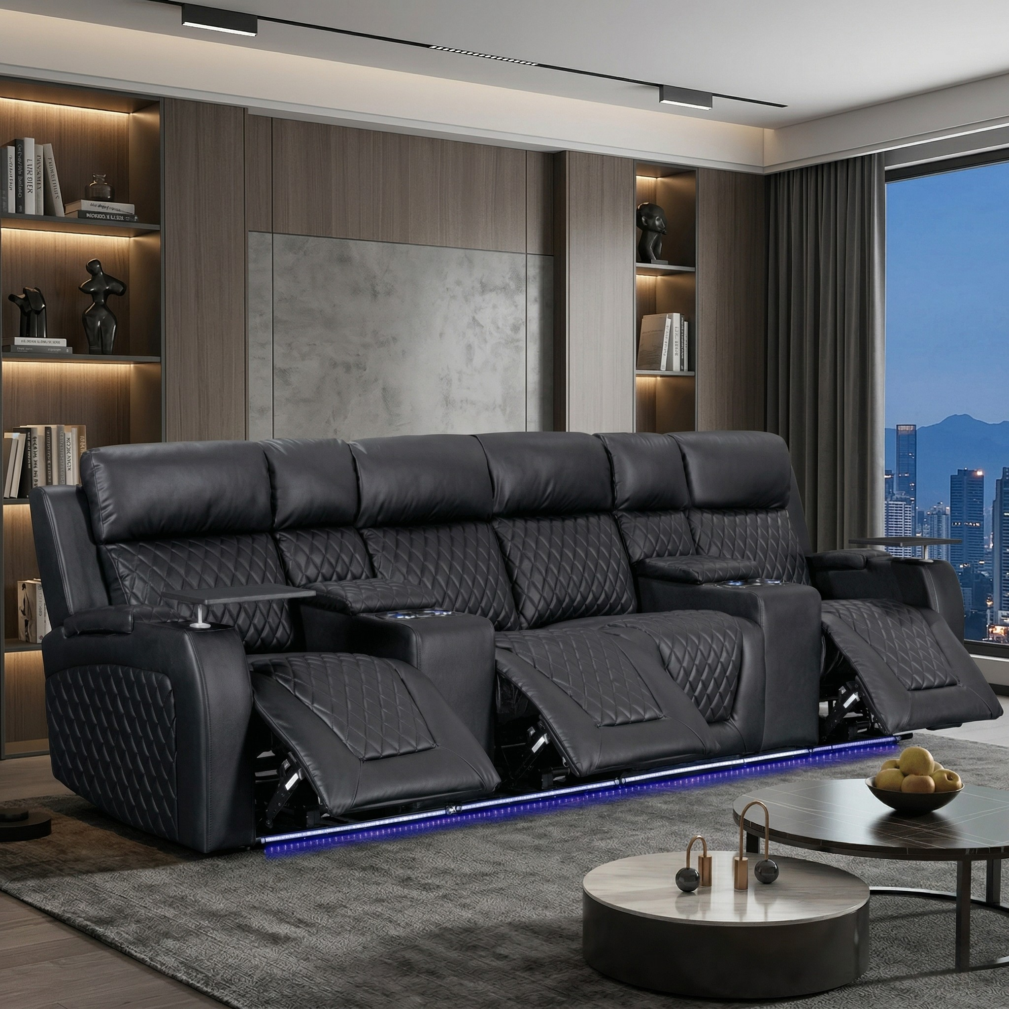 Modern living room with a large black leather sofa and cityscape view.