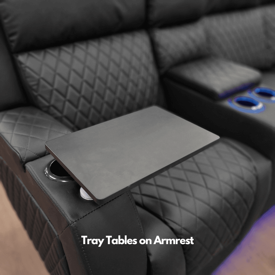 Black recliner sofa with quilted armrest, built-in tray table, and cup holders