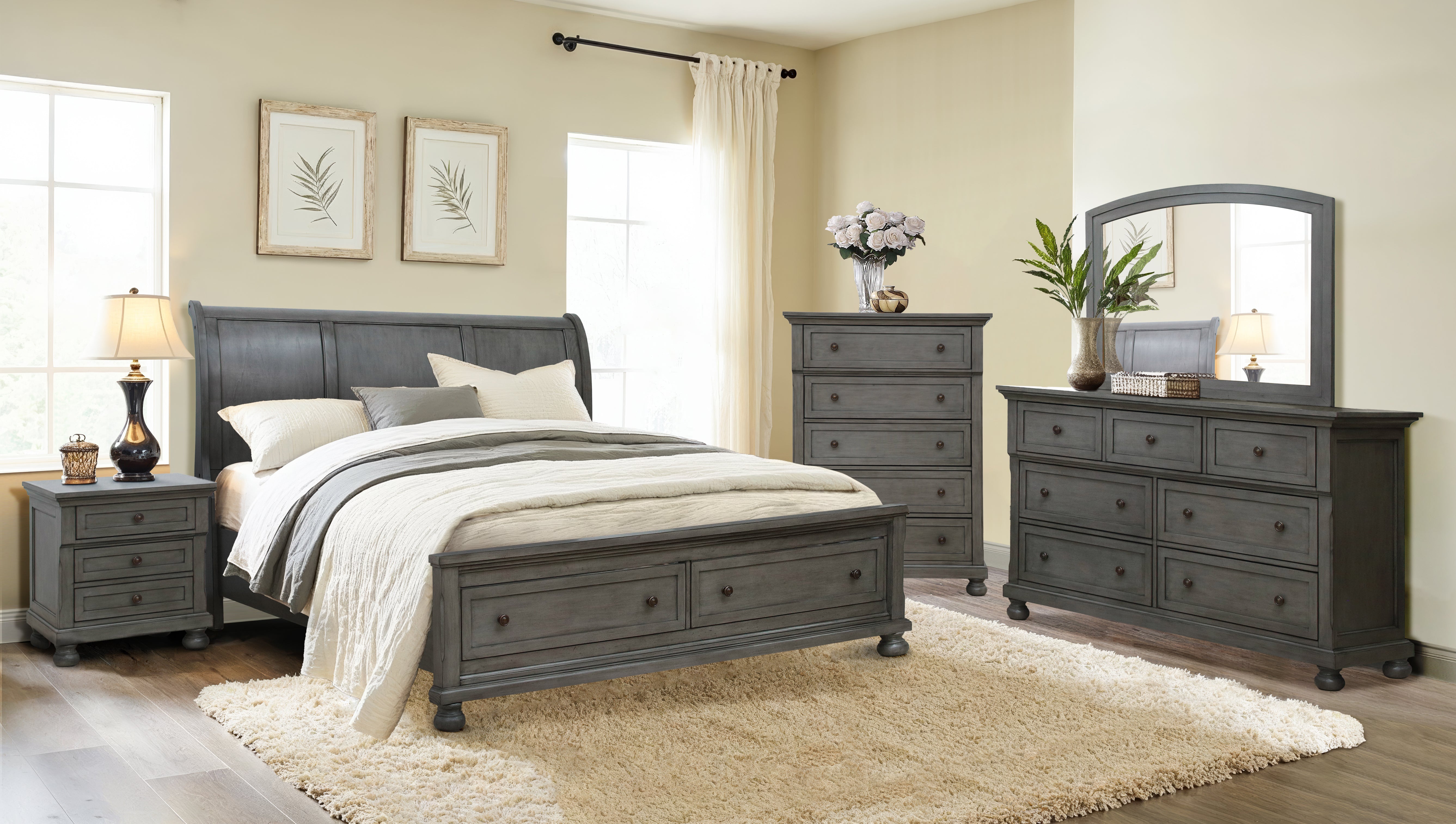 Gray bedroom furniture set with bed, dresser, and nightstands in a well-lit room.