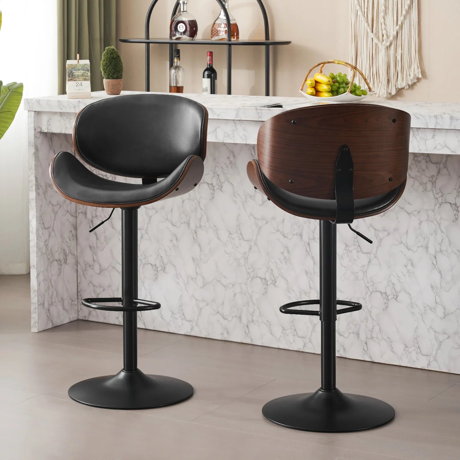 Two bar stools with black and wooden seats in a kitchen setting.
