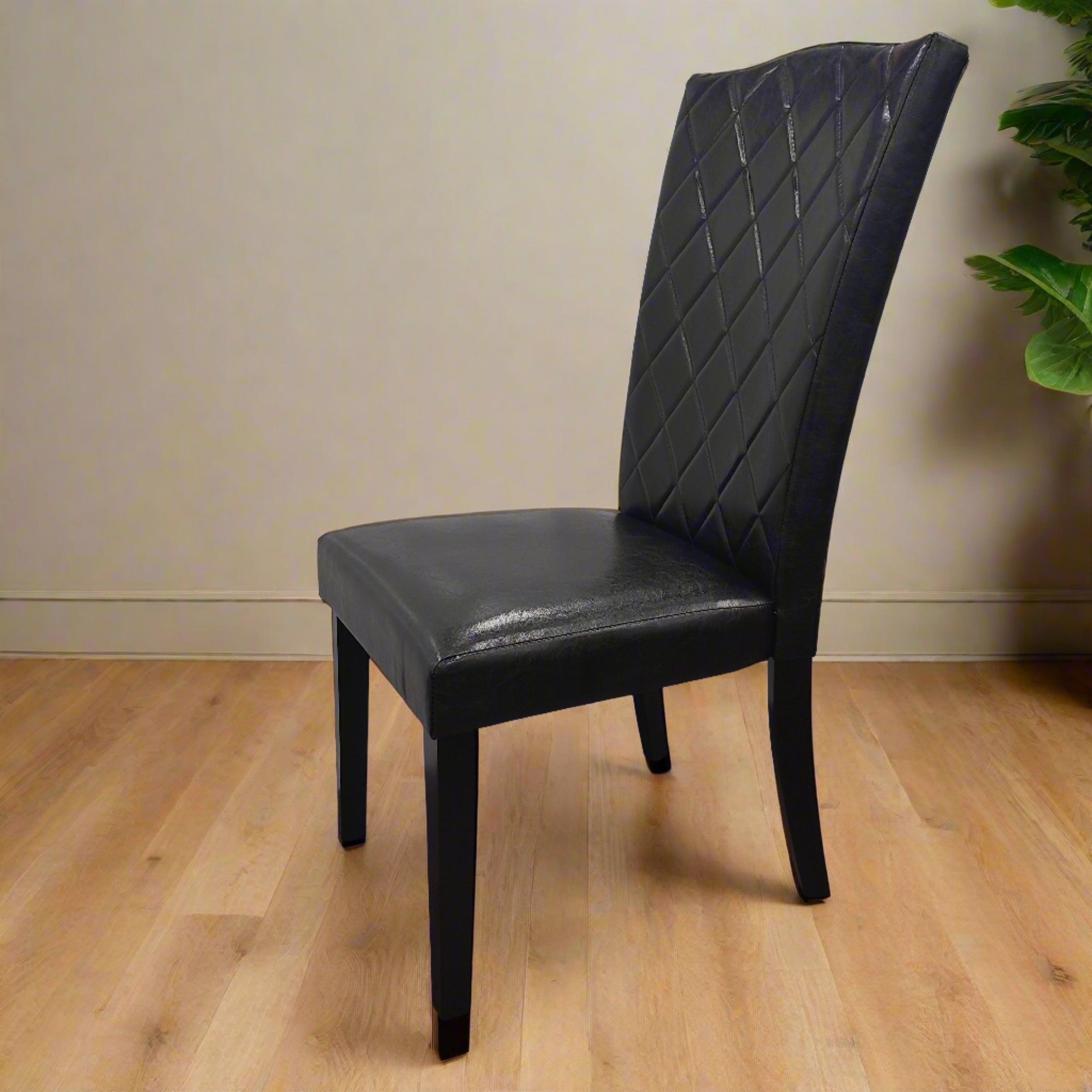 Black faux leather dining chair with diamond-stitched backrest on hardwood floor