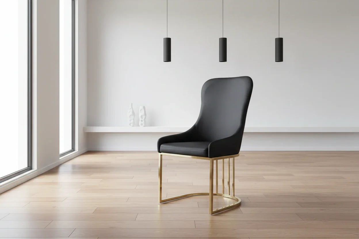 Black chair with gold legs in a minimalistic room with large windows.