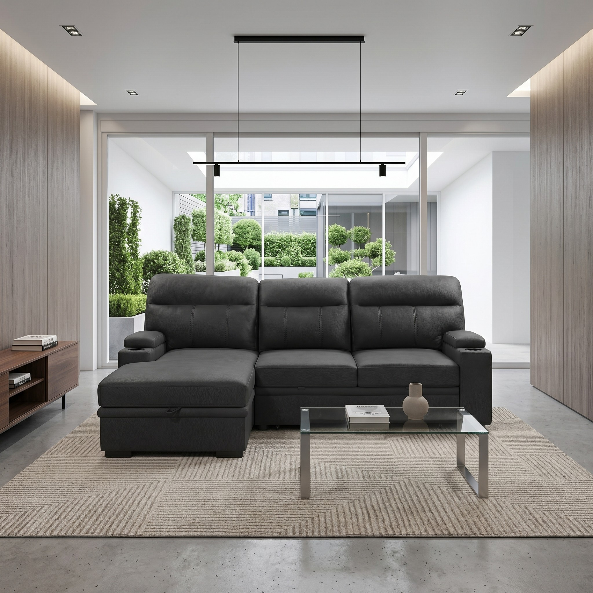 Modern living room with a black sofa bed, glass coffee table, and wooden sideboard.