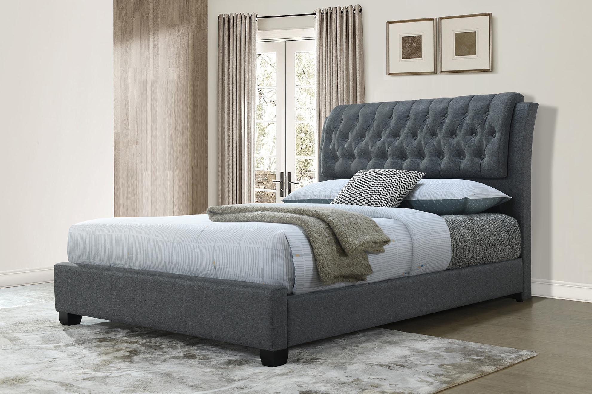 Modern grey upholstered bed with tufted headboard in a stylish bedroom setting