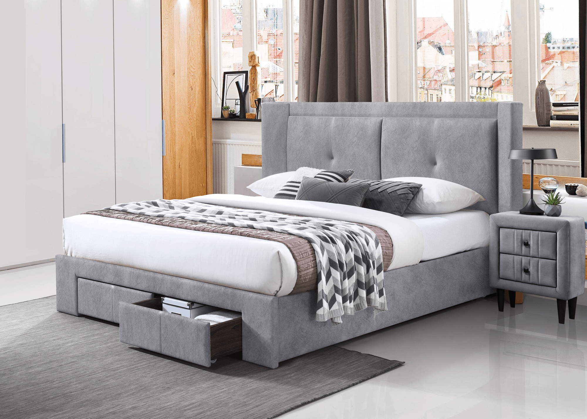 Modern grey upholstered bed with storage drawers in a bright bedroom setting