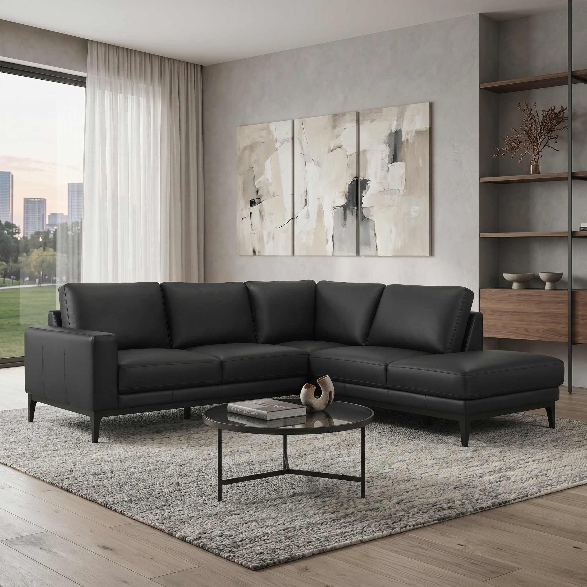 Modern living room with a black leather sectional sofa, coffee table, and abstract art on the wall.