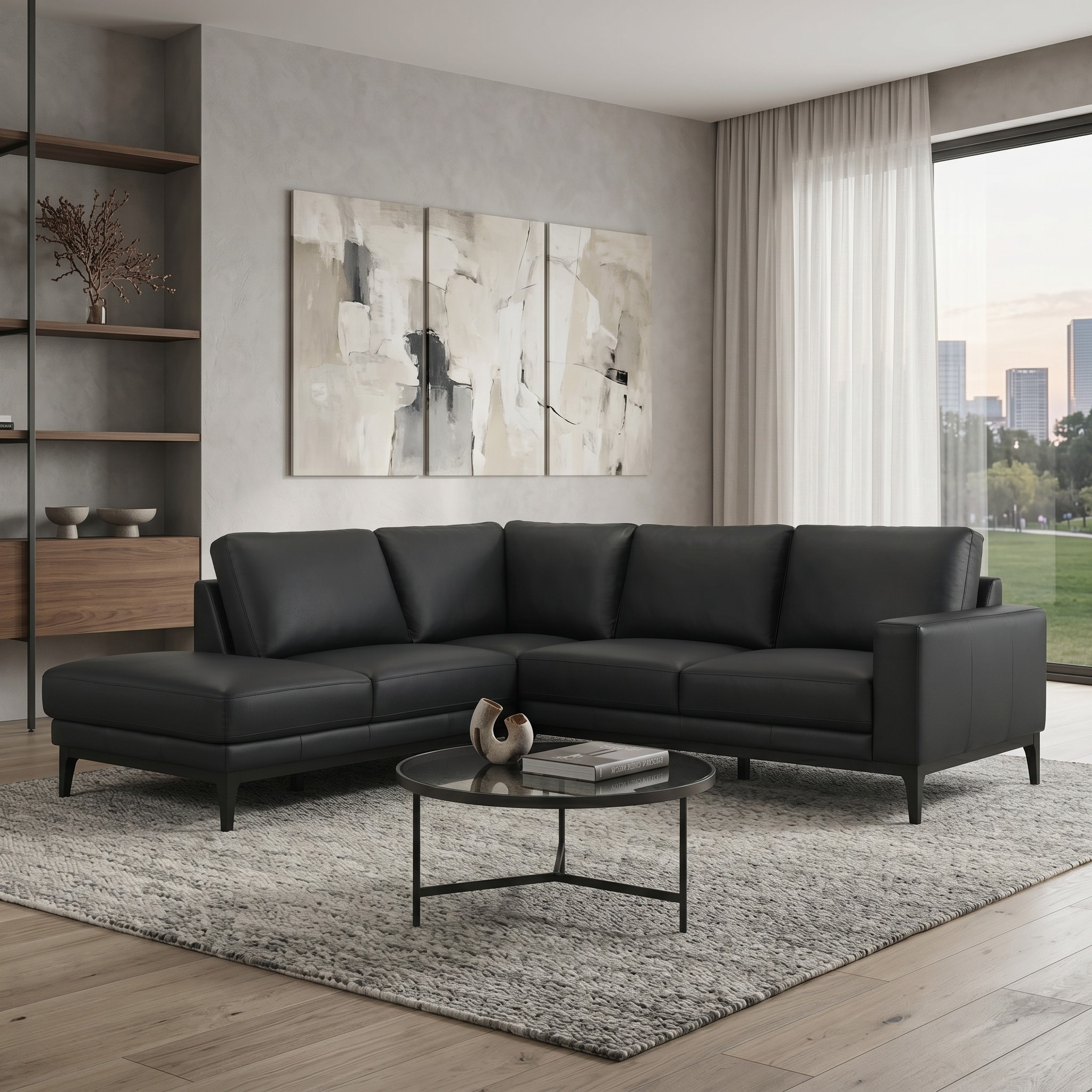 Modern living room with a black sectional sofa, coffee table, and abstract art on the wall.