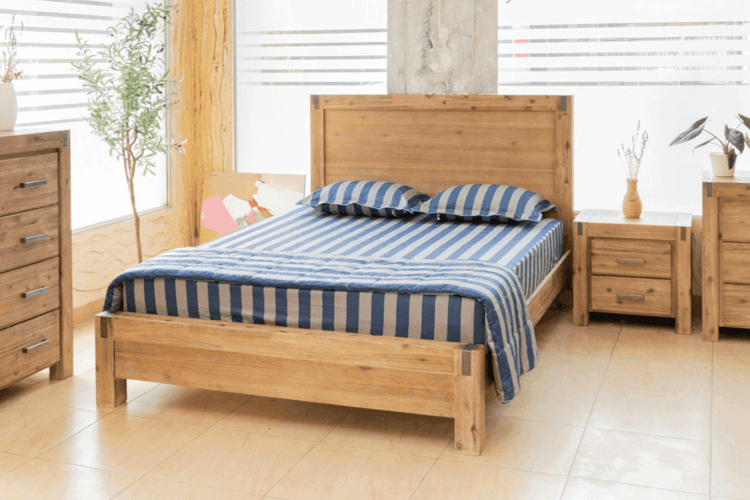 Modern wooden bedroom suite with striped bedding, matching bedside tables and dresser