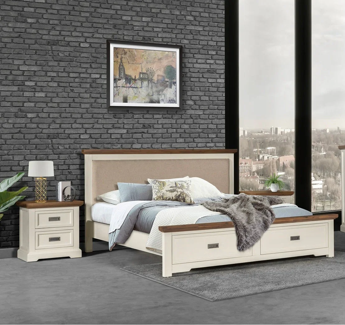 Bedroom with a bed, nightstand, and lamp against a brick wall.