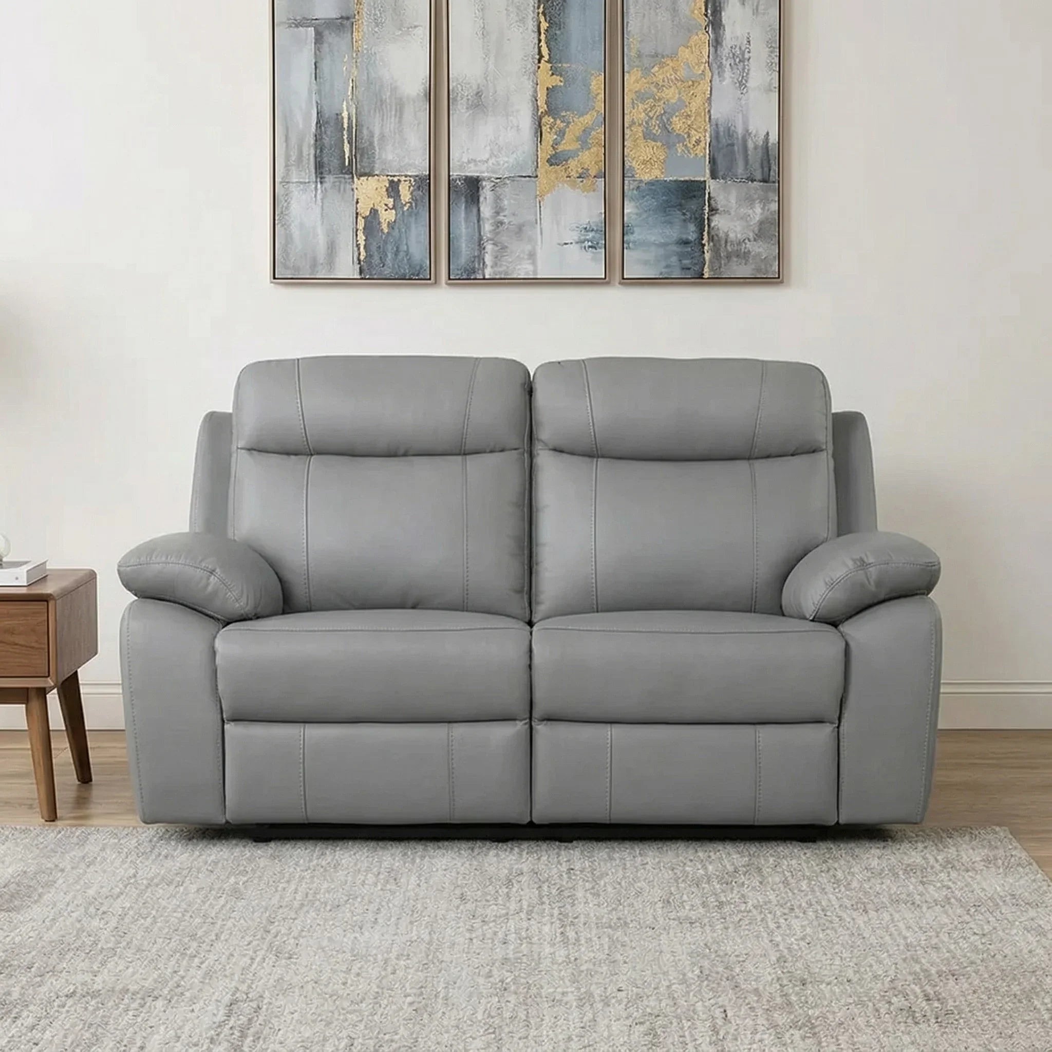 Latrobe 2 Seater Leather Recliner Lounge in grey leather with padded armrests and backrests, set in a modern living room with neutral decor.