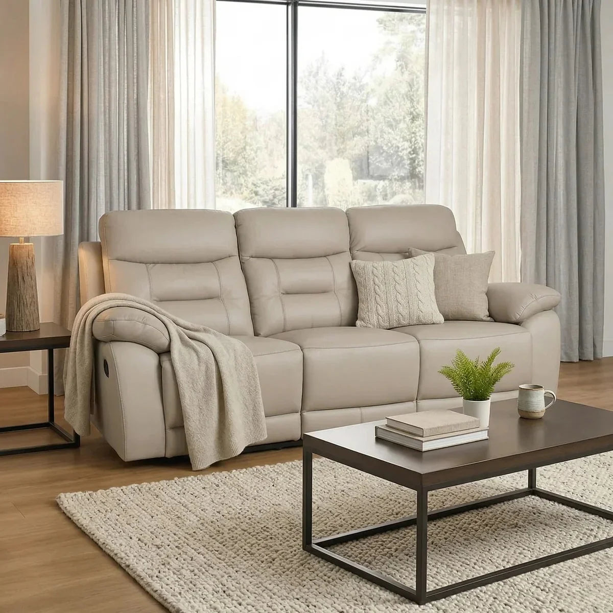 Beige recliner sofa in a living room with a coffee table and decor items.