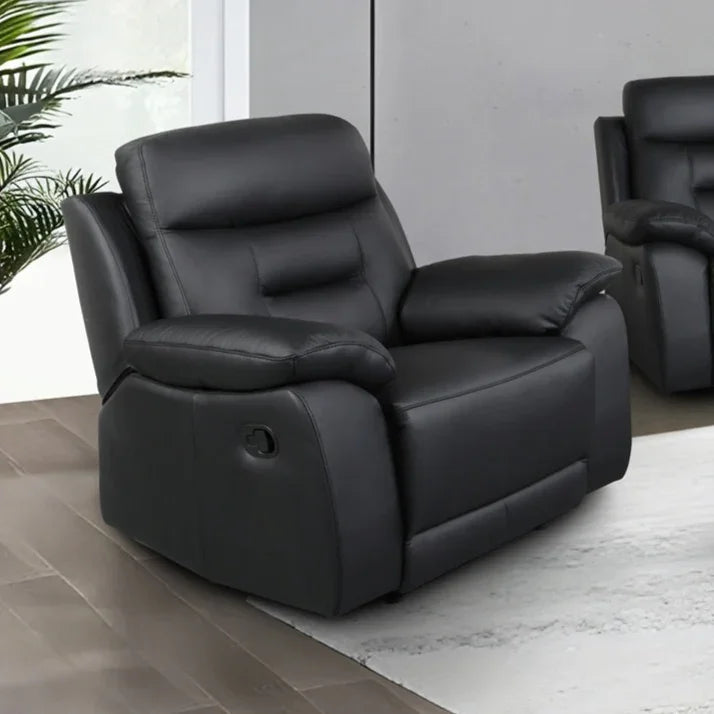 Black leather recliner armchair in modern living room setting