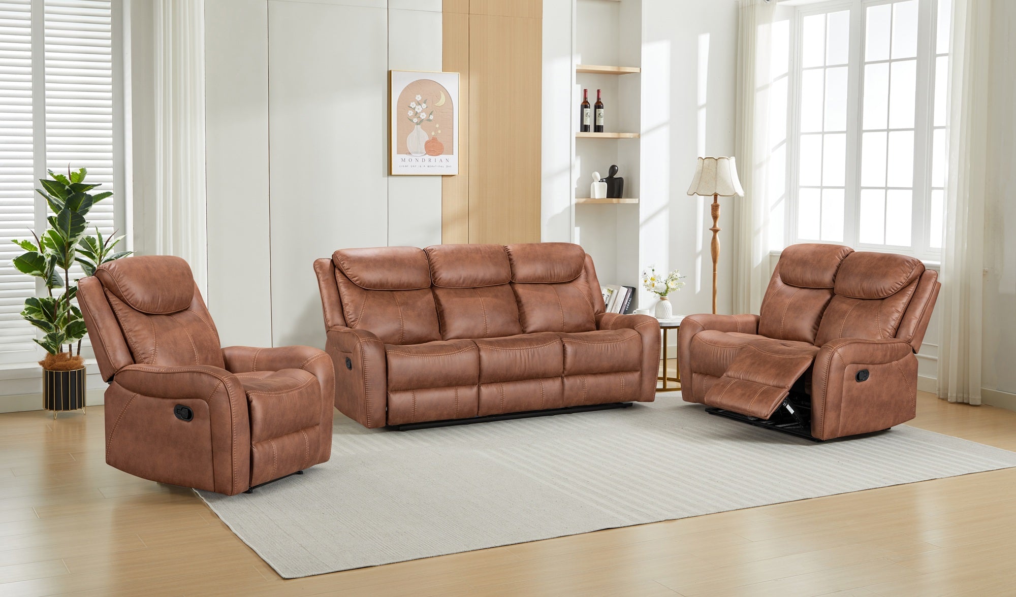 Brown fabric recliner sofa set in a living room with light wood flooring and large windows.