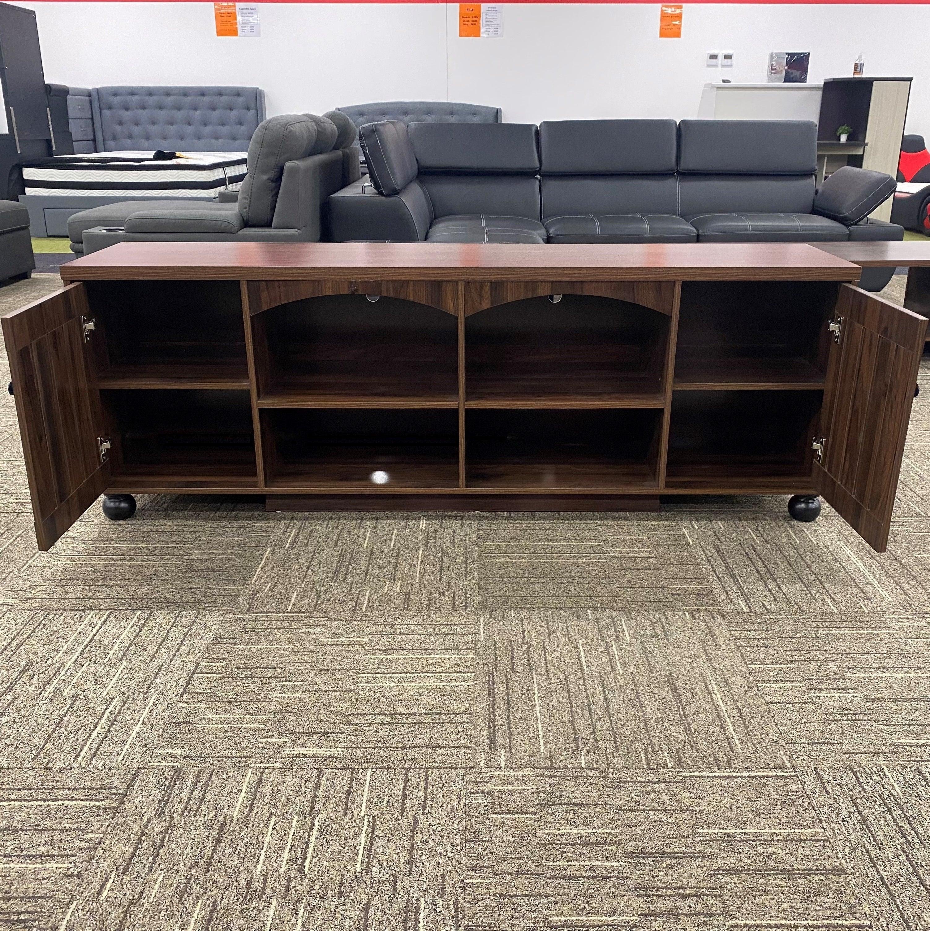 Montego TV Unit by The A2Z Furniture - a sleek and functional TV unit with 2 cabinet doors and 4 open shelves in a darker brown color.