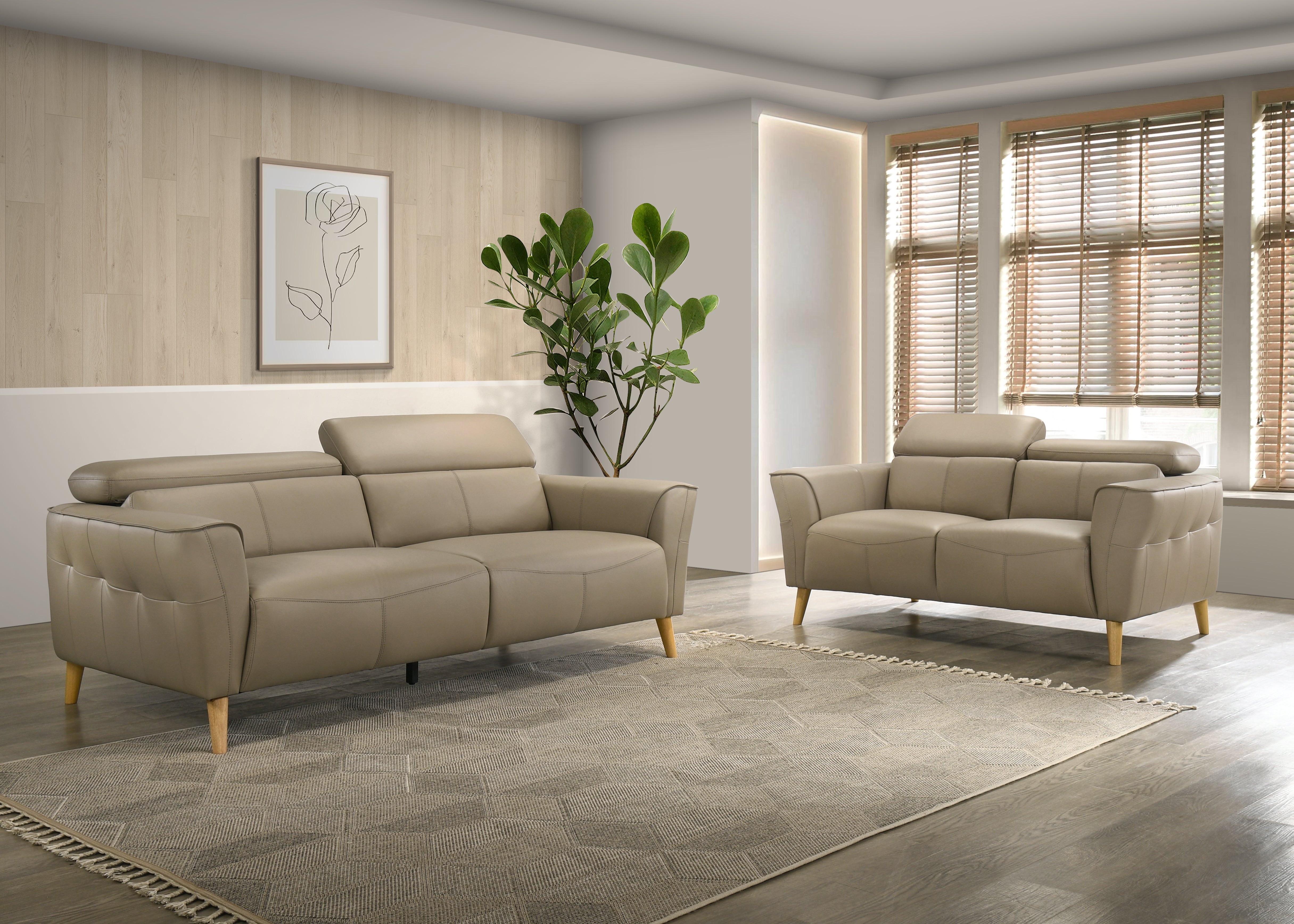 Beige sofa set in a modern living room with a plant and framed artwork.