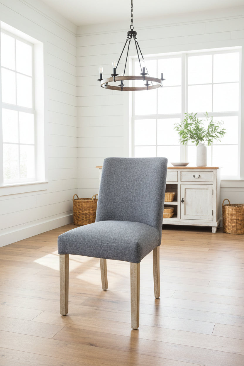 Gray chair in a bright room with wooden floor and white walls